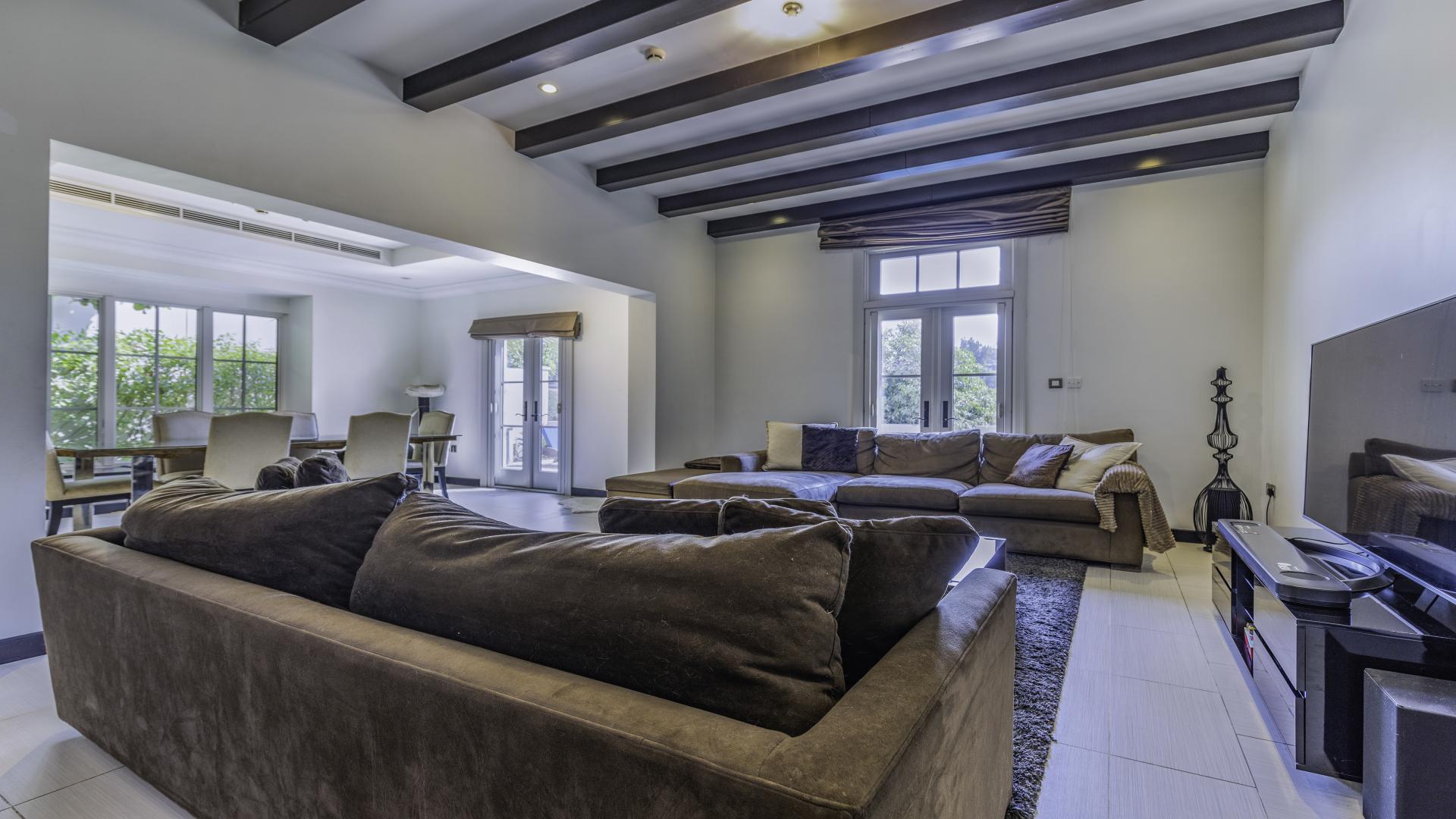 Luxurious living room in Doral Type villa, Jumeirah Golf Estates, with modern decor and TV
