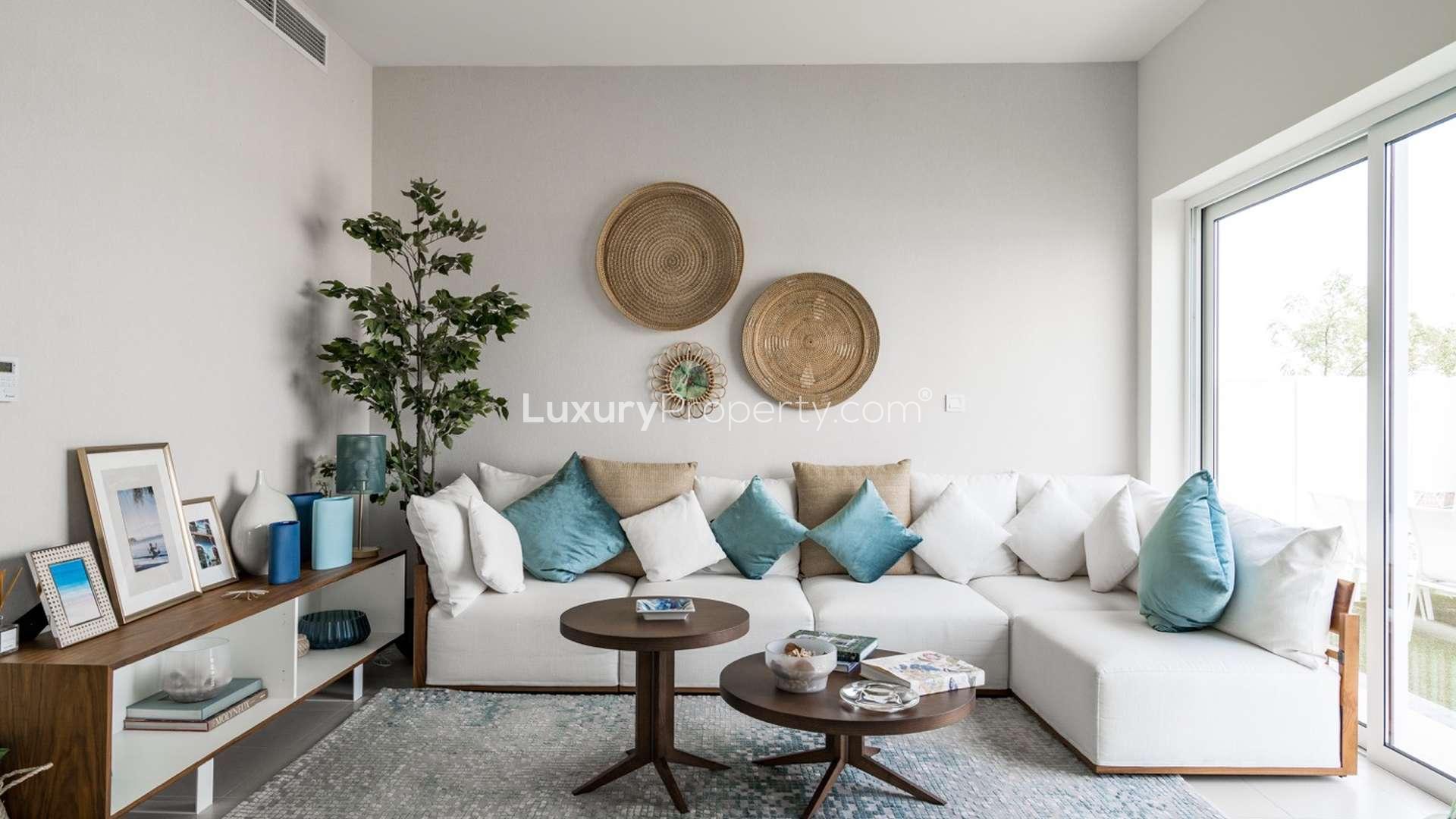 Elegant living room in 4-bedroom villa, Emaar South Golf Links, with modern decor and natural light