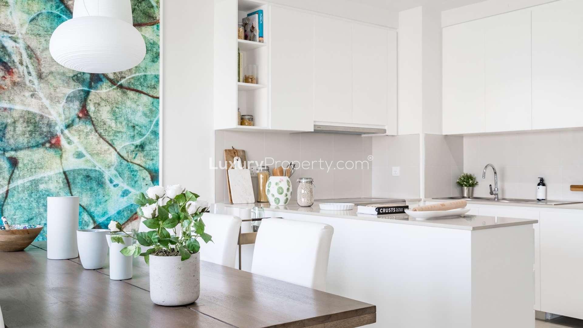 Modern living room in 4-bedroom villa, Emaar South Golf Links, with stylish decor and natural light