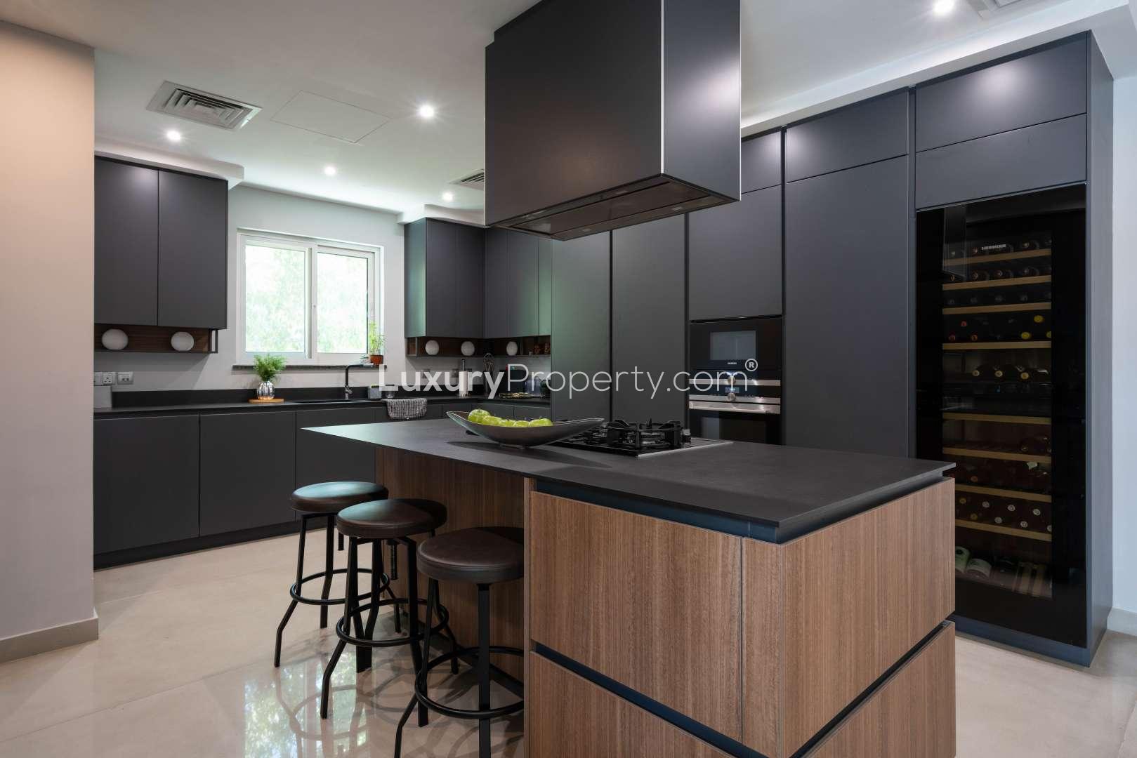 Modern kitchen in fully renovated Jumeirah Islands villa, featuring sleek cabinetry and island