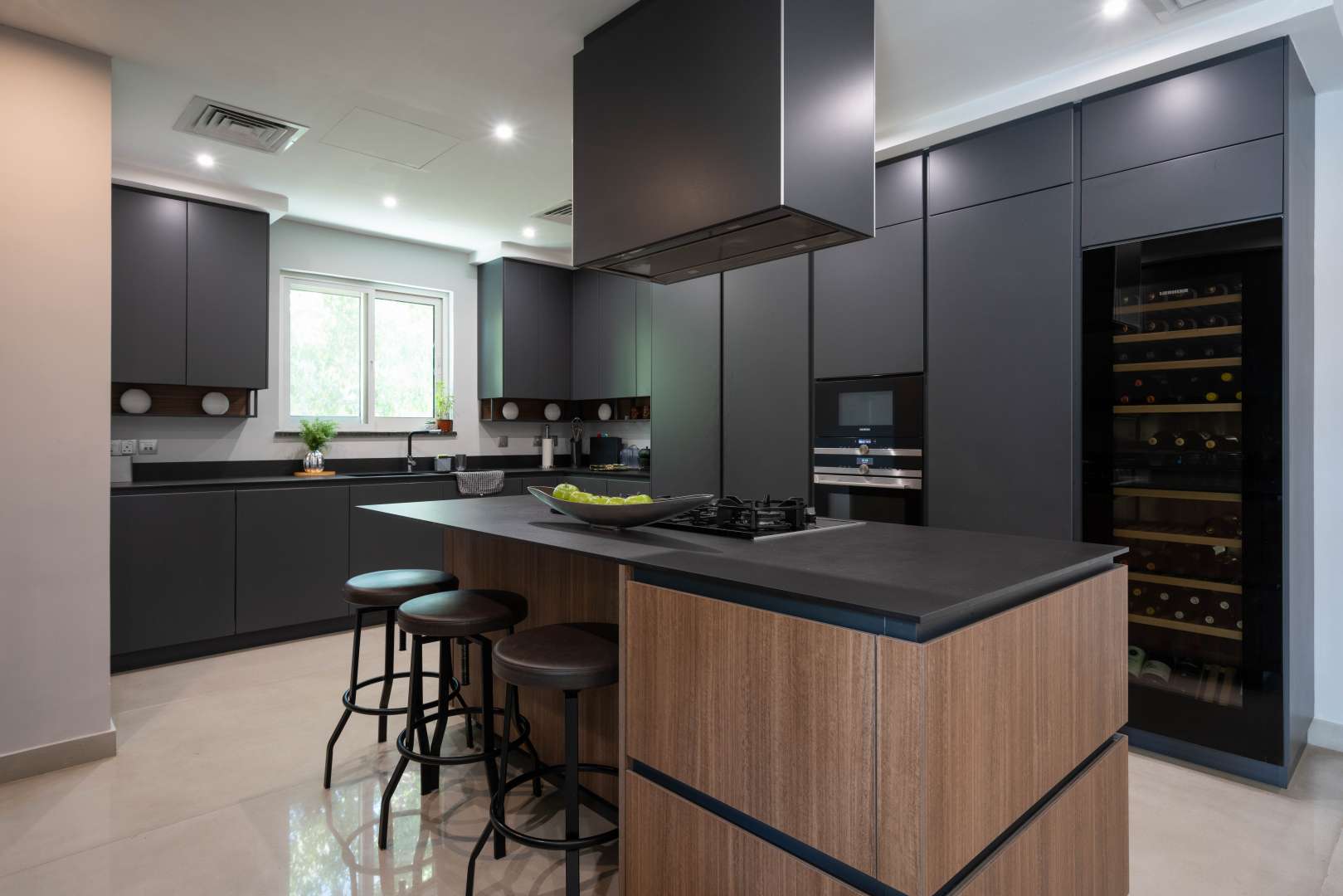 Modern kitchen in fully renovated Jumeirah Islands villa, featuring sleek cabinetry and island