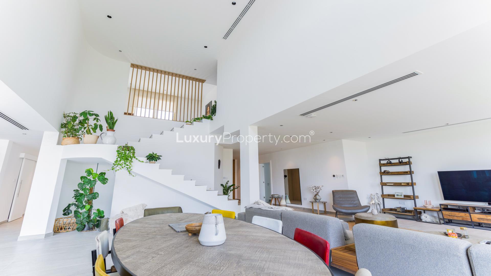 Living room with lake view in upgraded Jumeirah Islands villa, European Clusters
