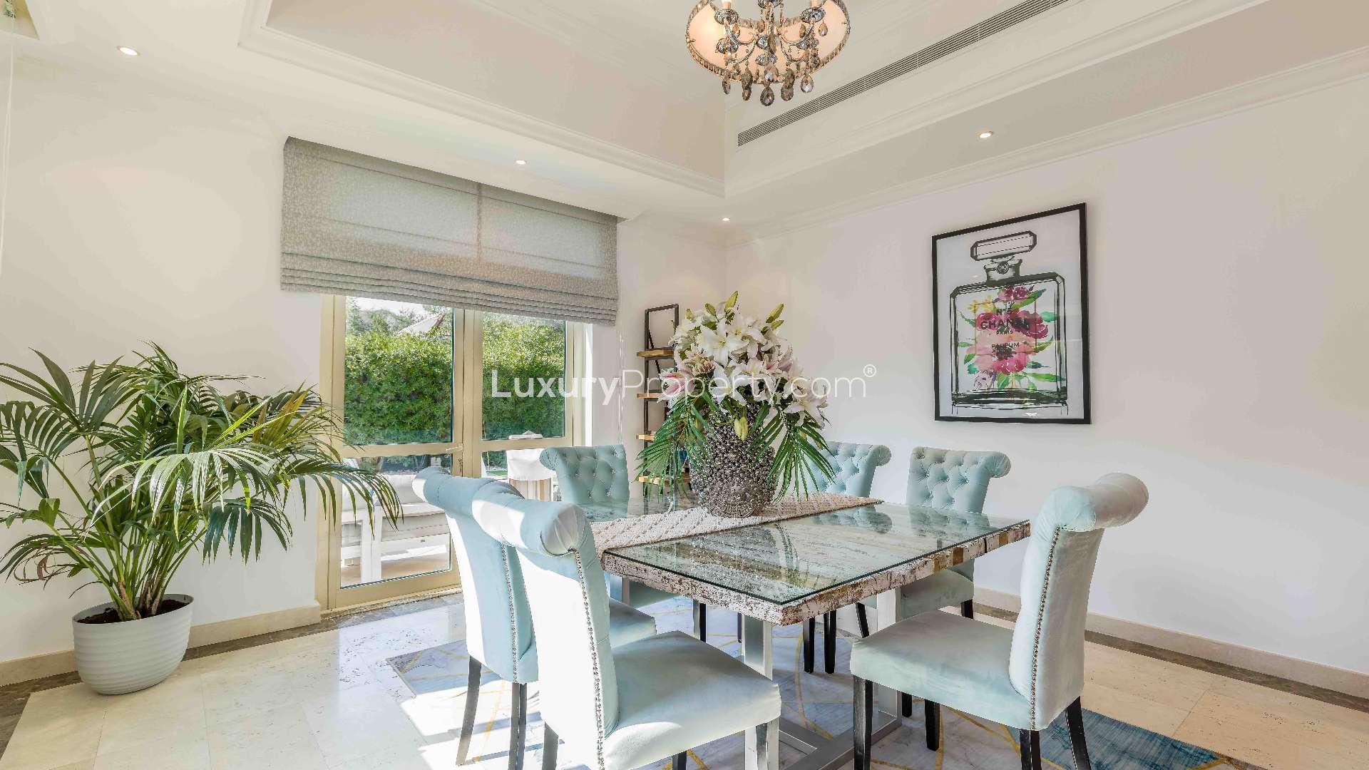 "Luxury 4-bedroom villa on corner plot in Jumeirah Islands, European Clusters for sale.",Elegant dining room in Jumeirah Islands villa, featuring chic decor and natural light