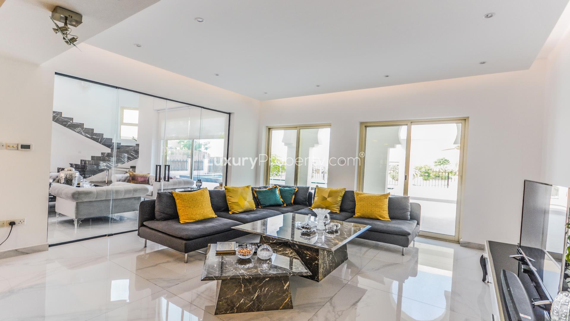Modern living room in furnished villa, European Clusters, Jumeirah Islands, overlooking garden