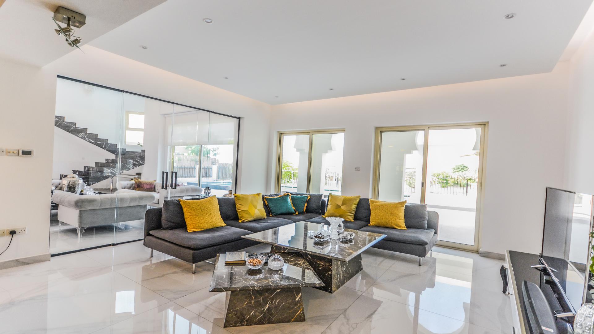 Modern living room in furnished villa, European Clusters, Jumeirah Islands, overlooking garden