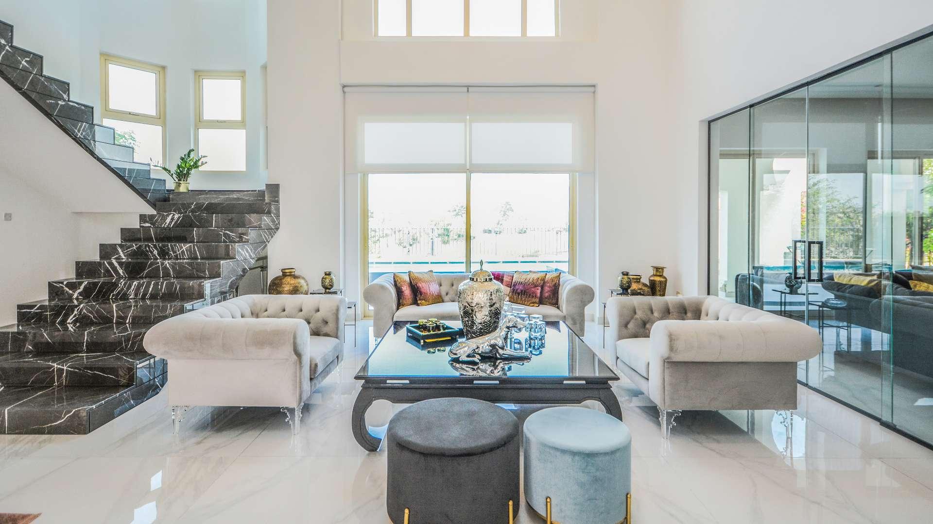 "Luxurious villa with private pool in Jumeirah Islands European Clusters, for sale.",Luxurious living room in furnished Jumeirah Islands villa with elegant decor and lake view