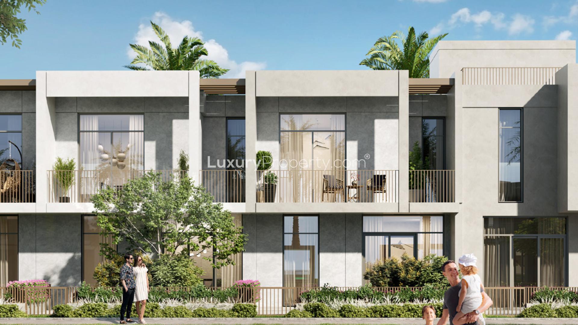 "Modern kitchen in four-bedroom villa, EMAAR South, Dubai South, with dining area and garden view.",Modern four-bedroom villa exterior in EMAAR South, Dubai South, with lush landscaping