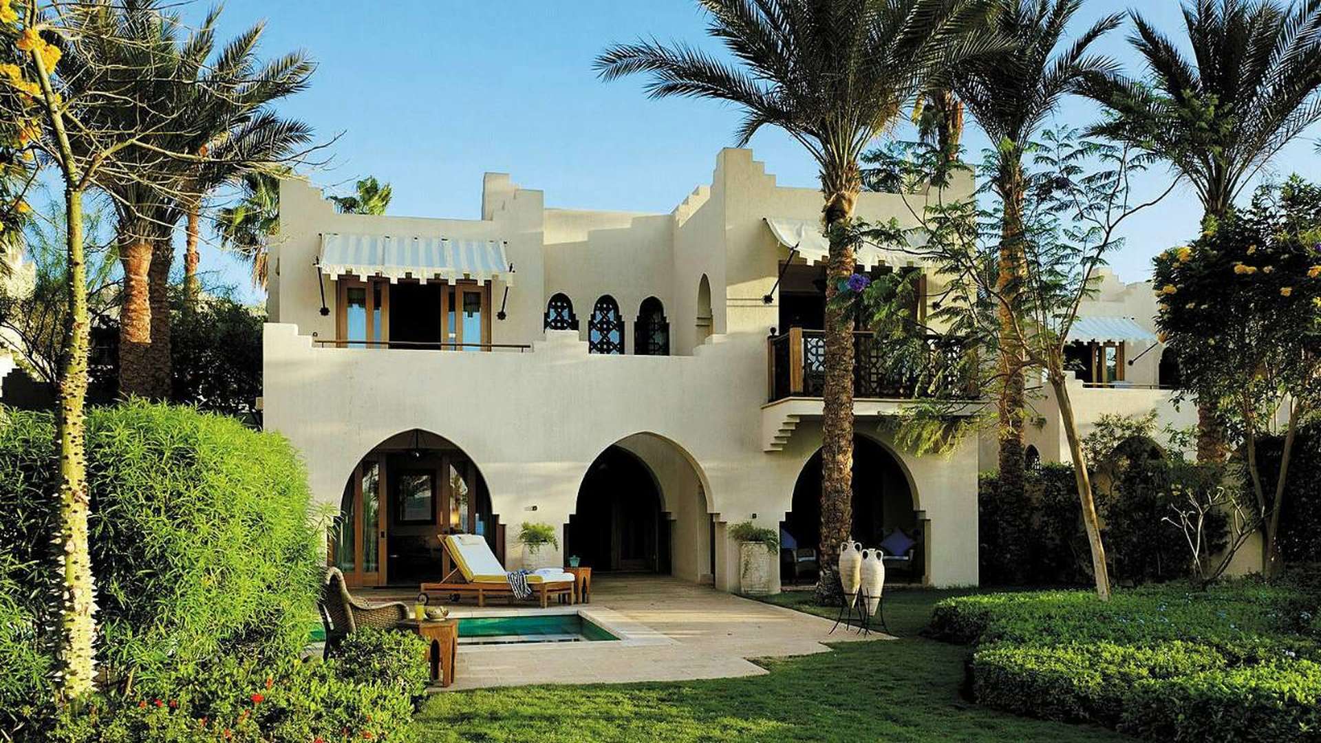 Elegant bedroom in Sharm El Sheikh villa with ornate windows and traditional furnishings