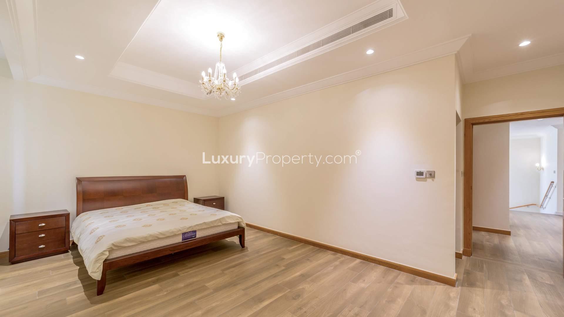 Beachfront villa exterior with palm trees on Palm Jumeirah, Garden Homes, Frond A