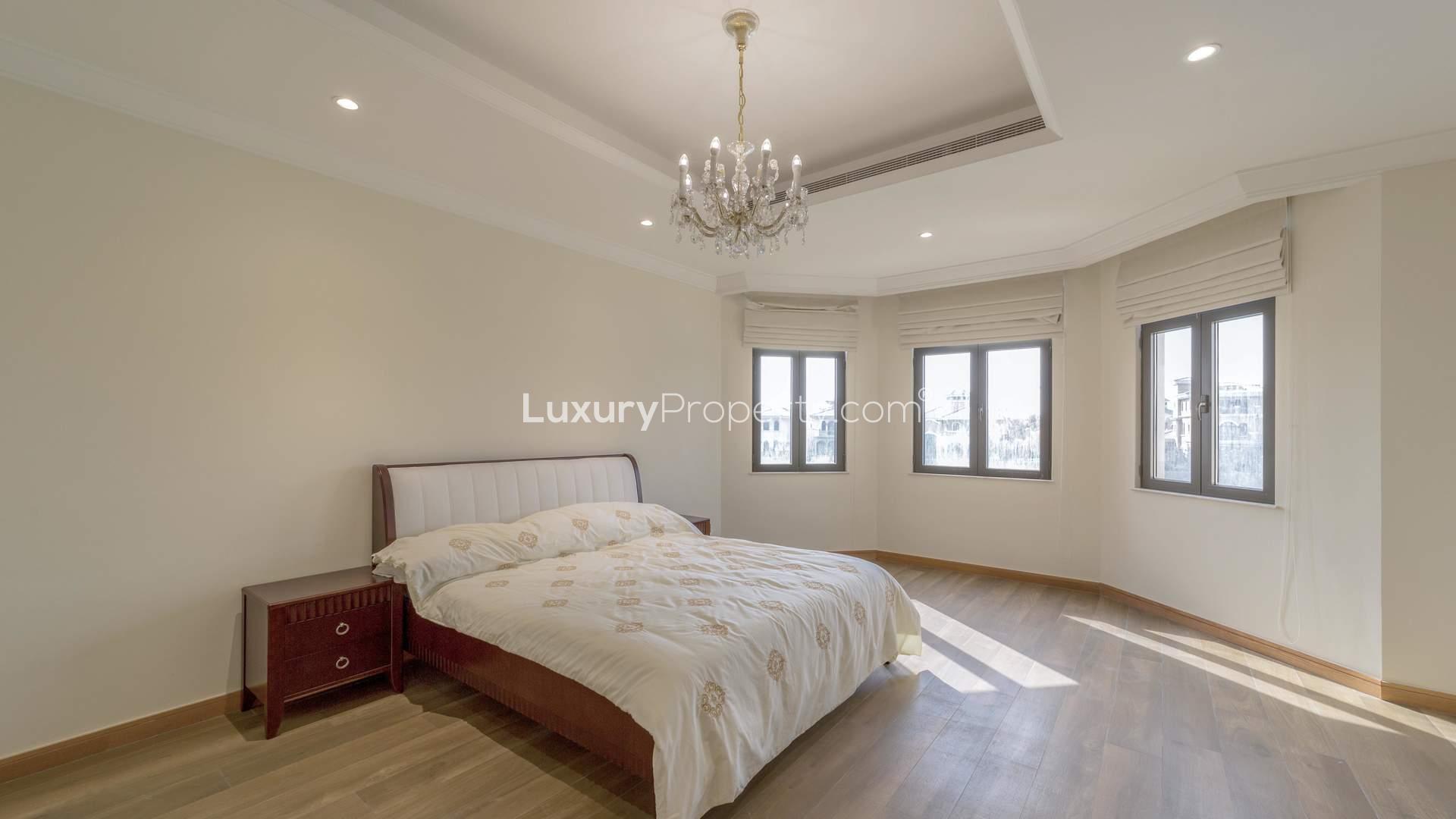 Luxurious bedroom in 4-bed beachfront villa, Palm Jumeirah Garden Homes, with elegant chandelier