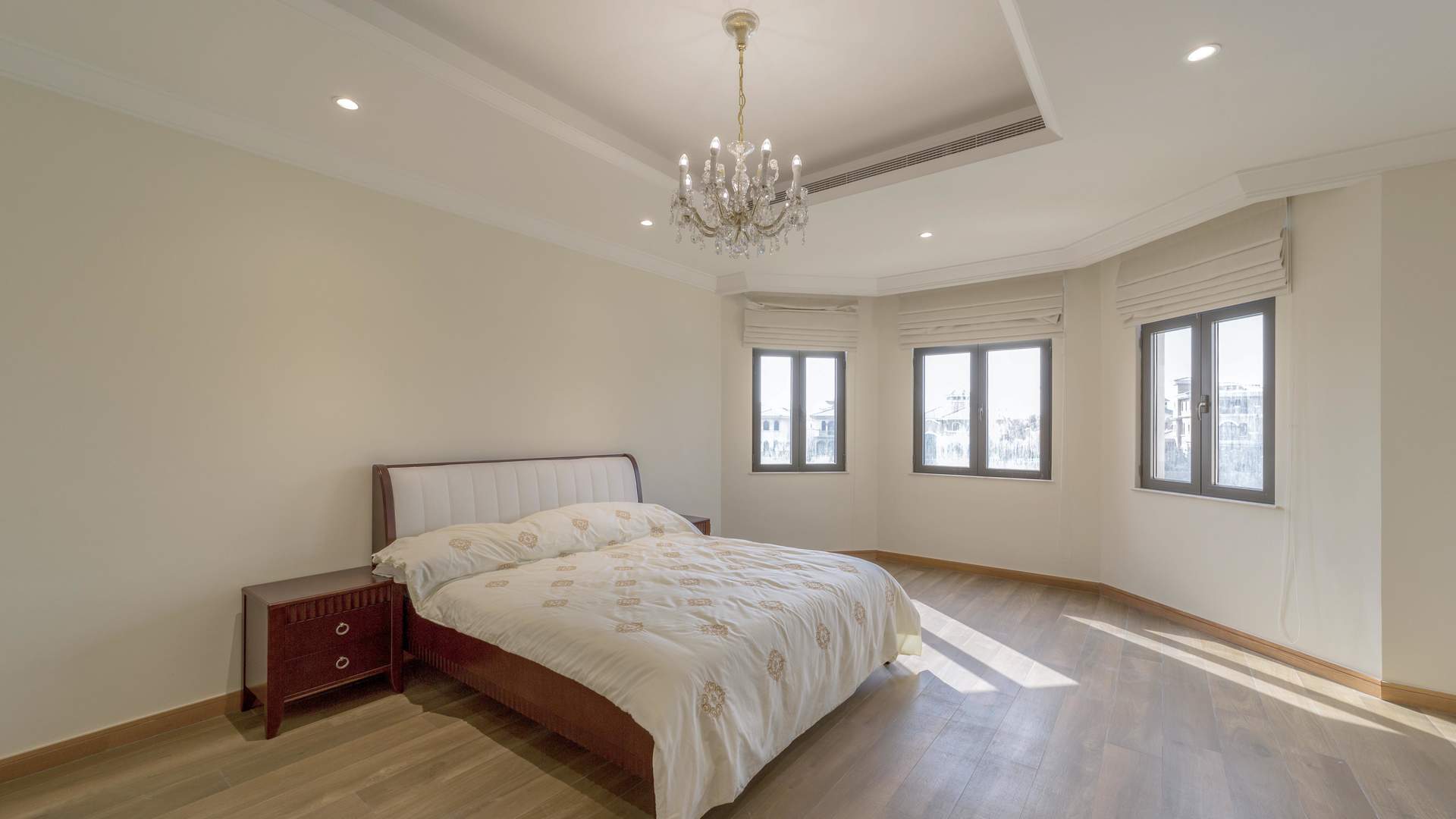 Luxurious bedroom in 4-bed beachfront villa, Palm Jumeirah Garden Homes, with elegant chandelier