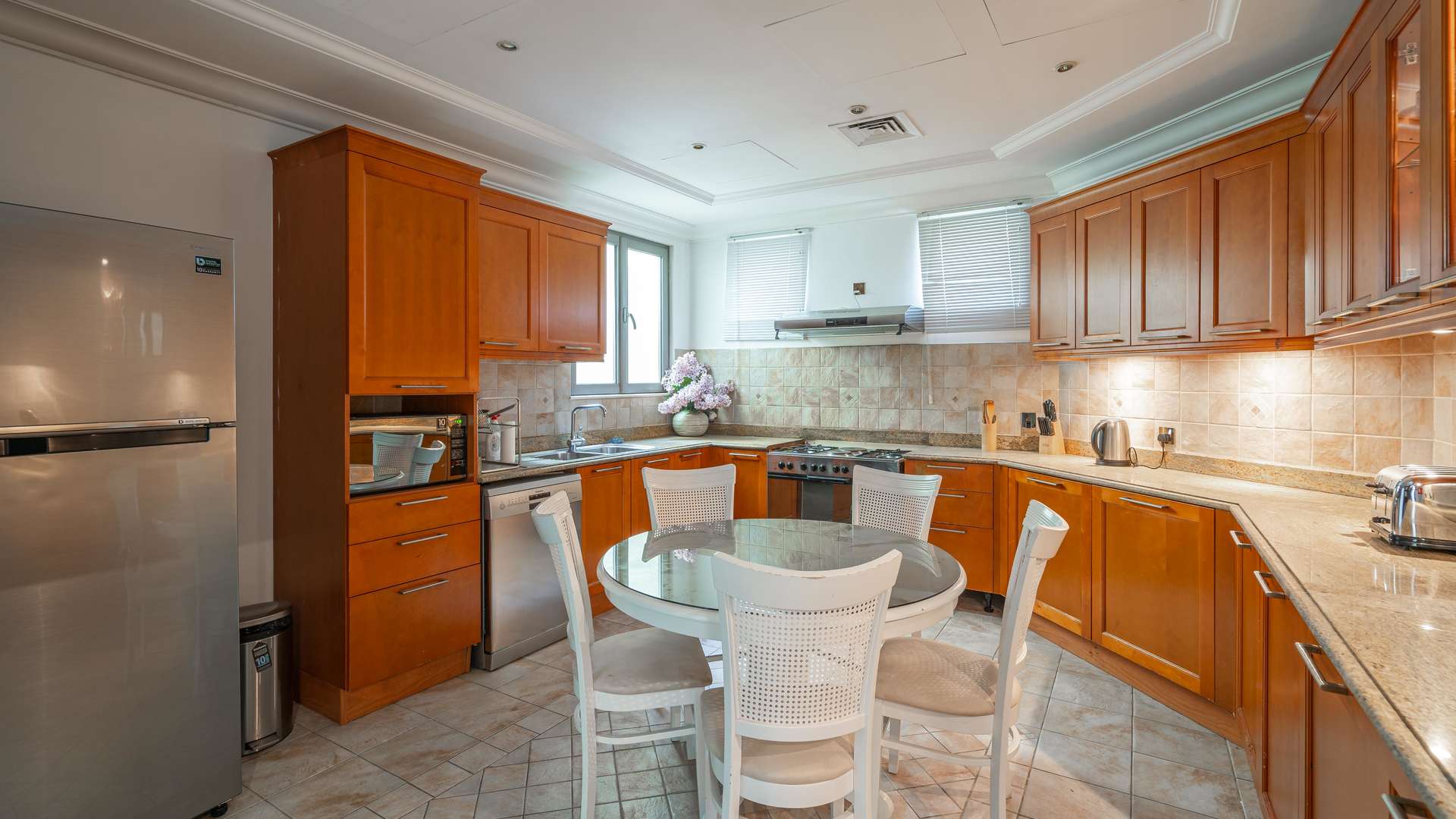 Bathroom in Palm Jumeirah villa with granite countertop and tiled walls, luxurious fittings