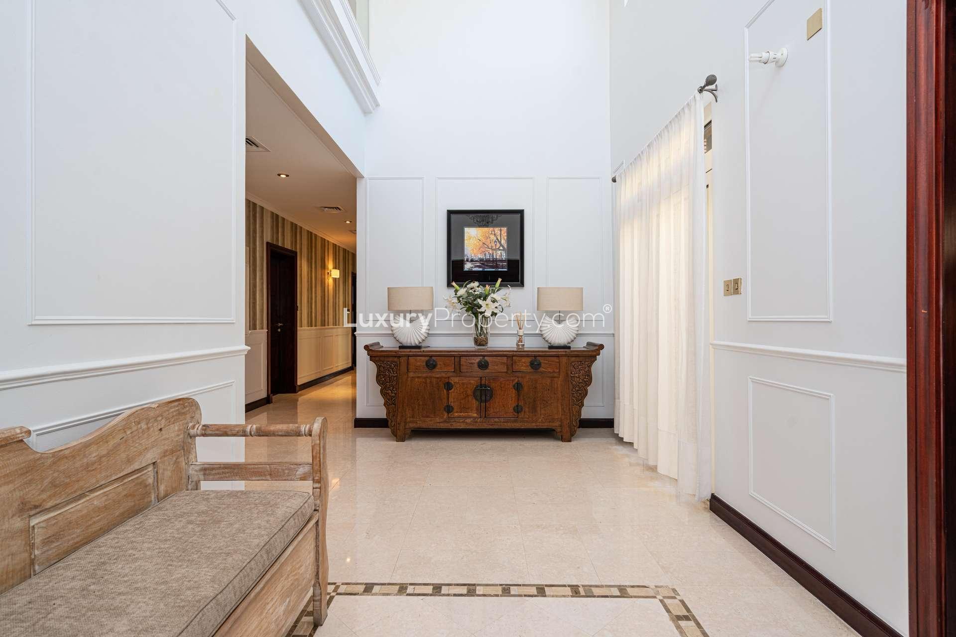 Interior staircase of upgraded beachfront villa, Palm Jumeirah, with glass railing and natural light