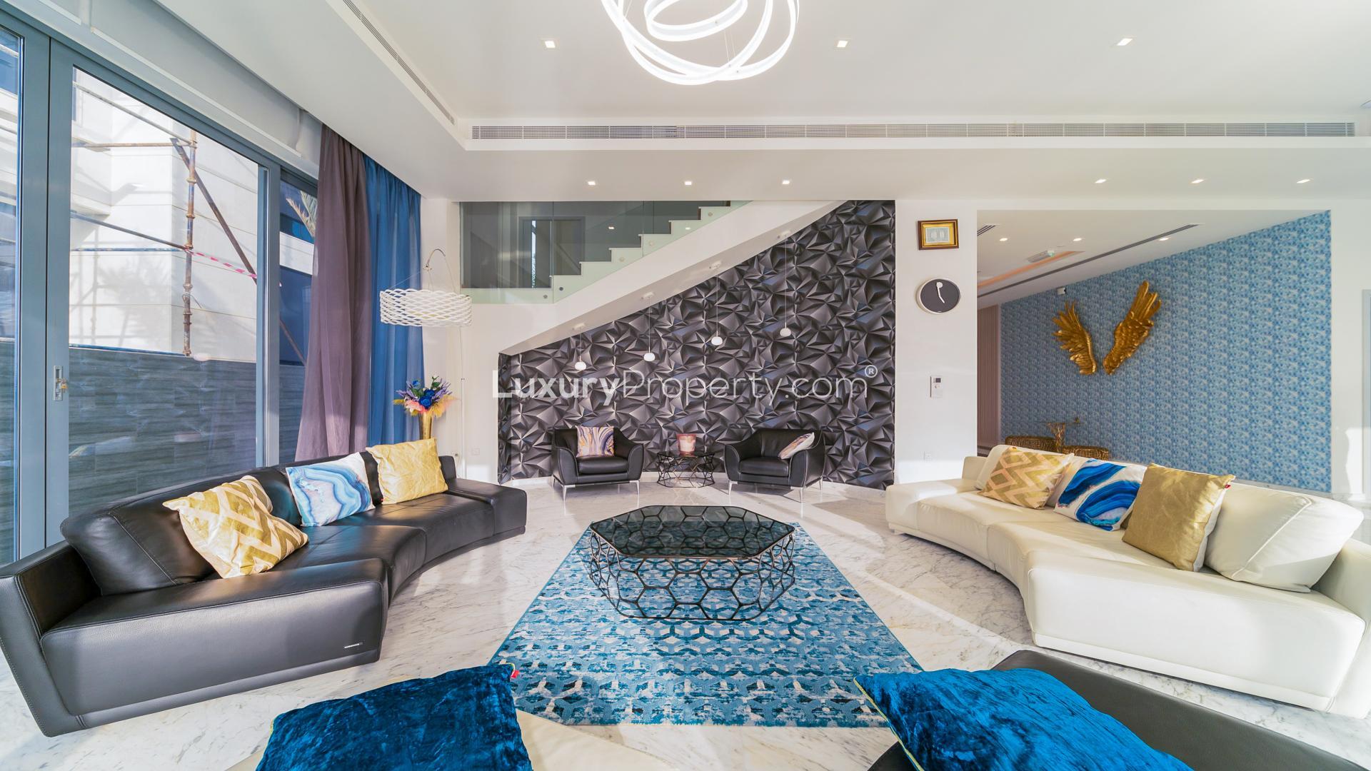 Luxurious living room in Palm Jumeirah villa with modern decor and pool view