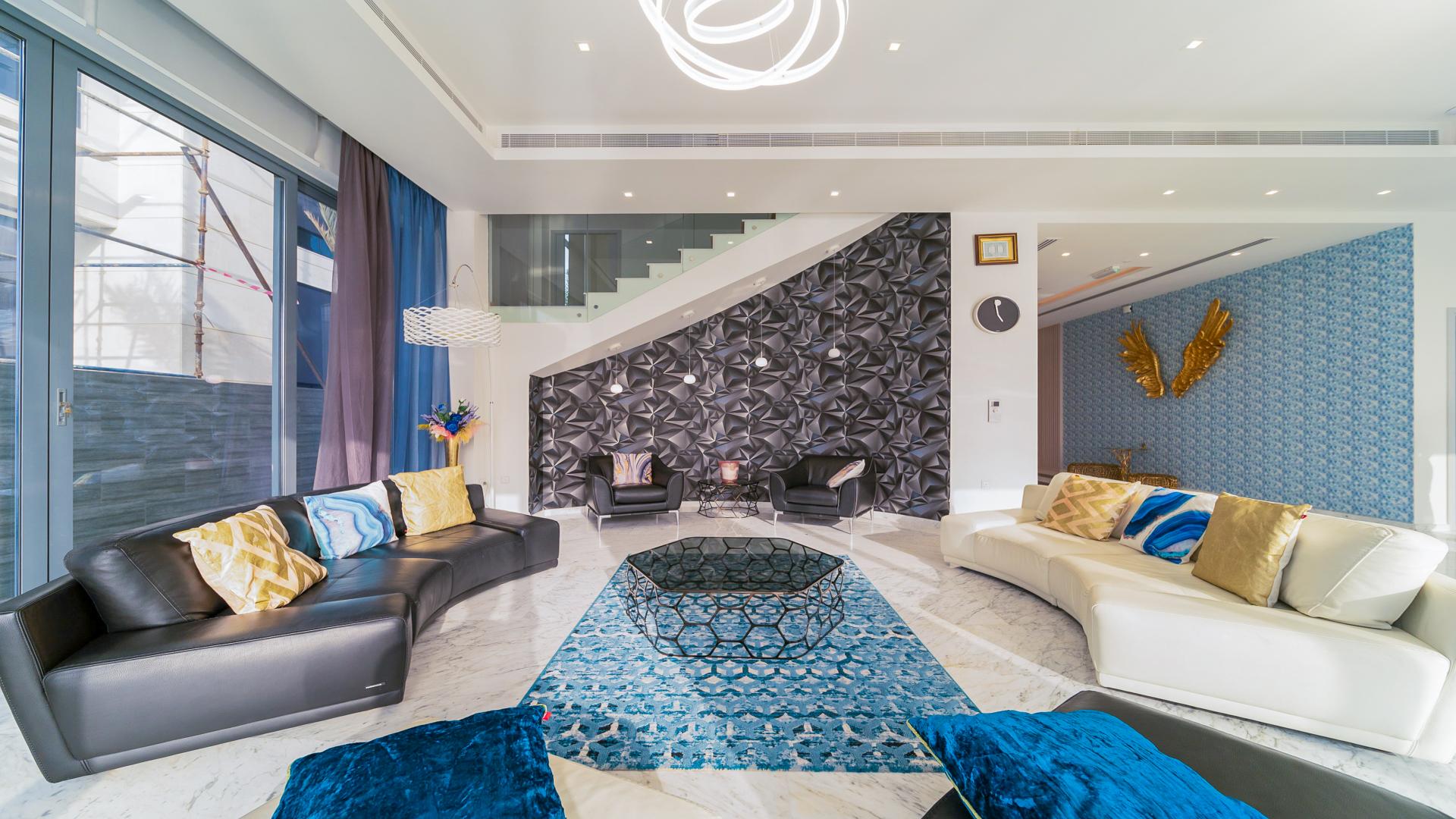 Luxurious living room in Palm Jumeirah villa with modern decor and pool view
