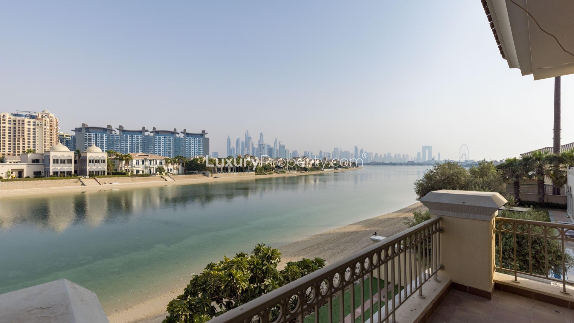Luxurious Palm Jumeirah villa interior with large windows and garden view, available for rent