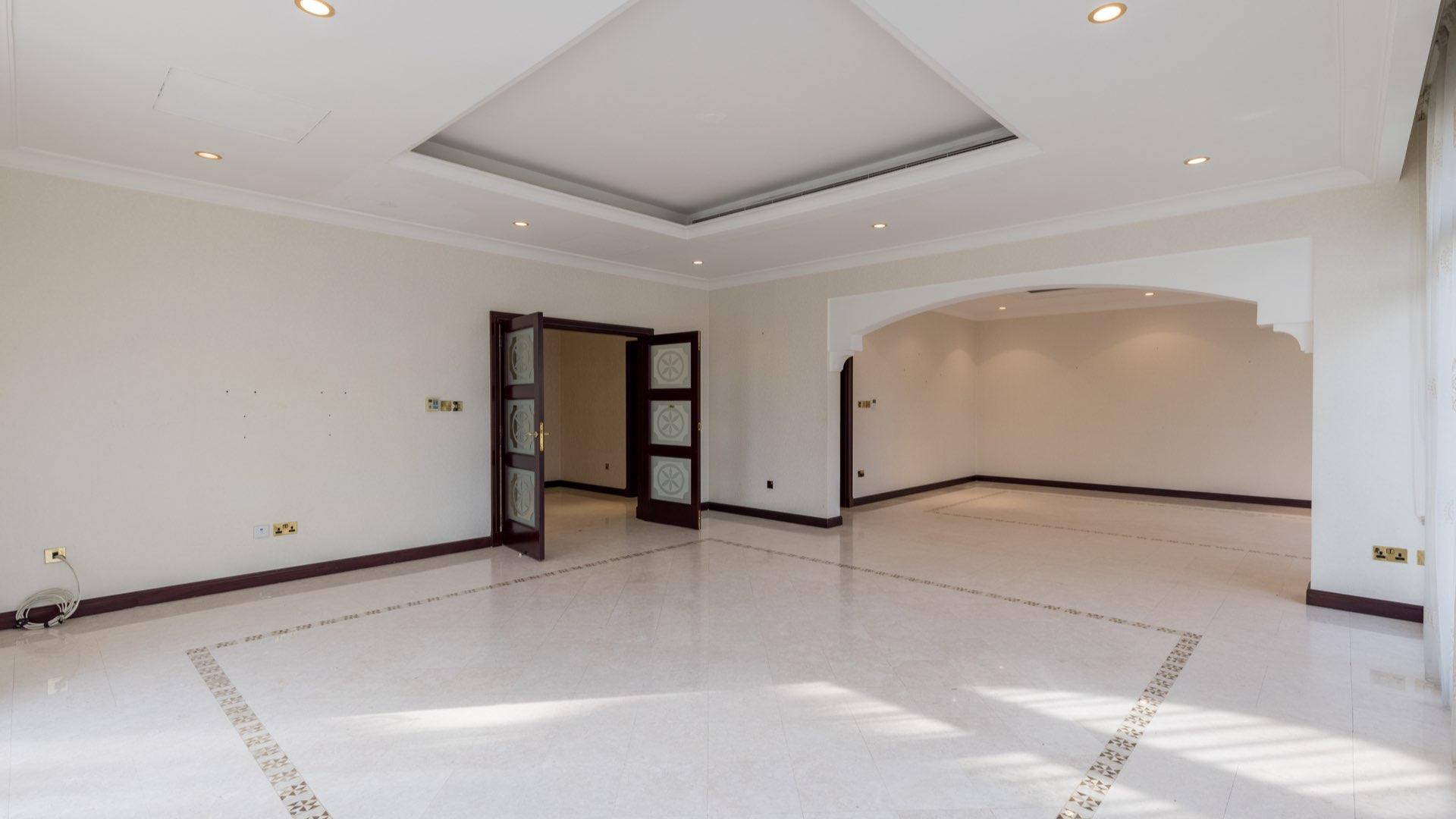 Spacious living area in Palm Jumeirah villa with large windows and elegant flooring