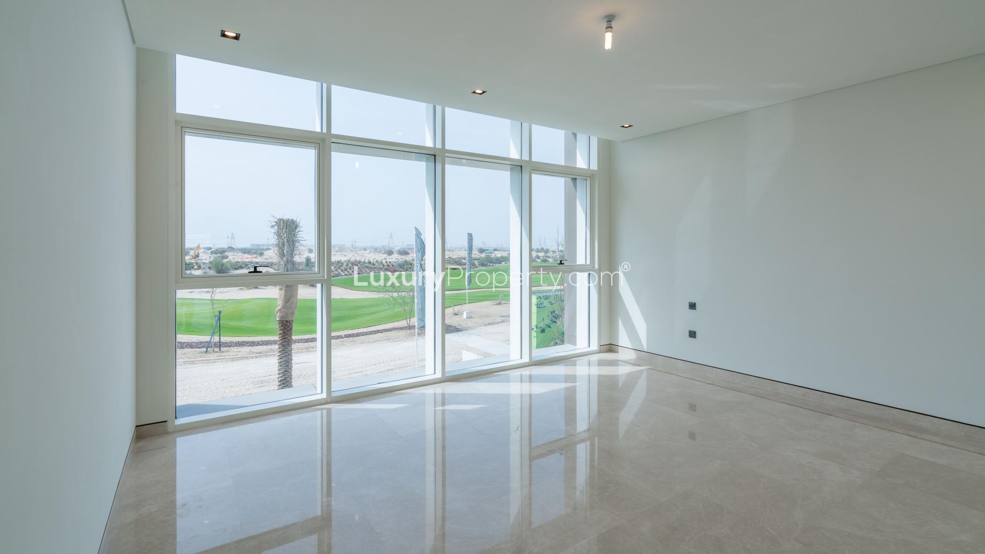 Bright room with large windows overlooking golf course in Dubai Hills Estate villa