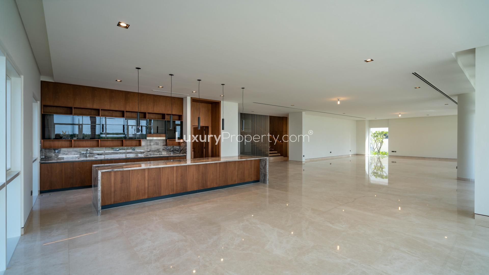 "Spacious Dubai Hills Estate villa entrance with modern design and elegant staircase in Golf Place.",Luxurious open-plan kitchen and living area in Dubai Hills Estate villa for sale