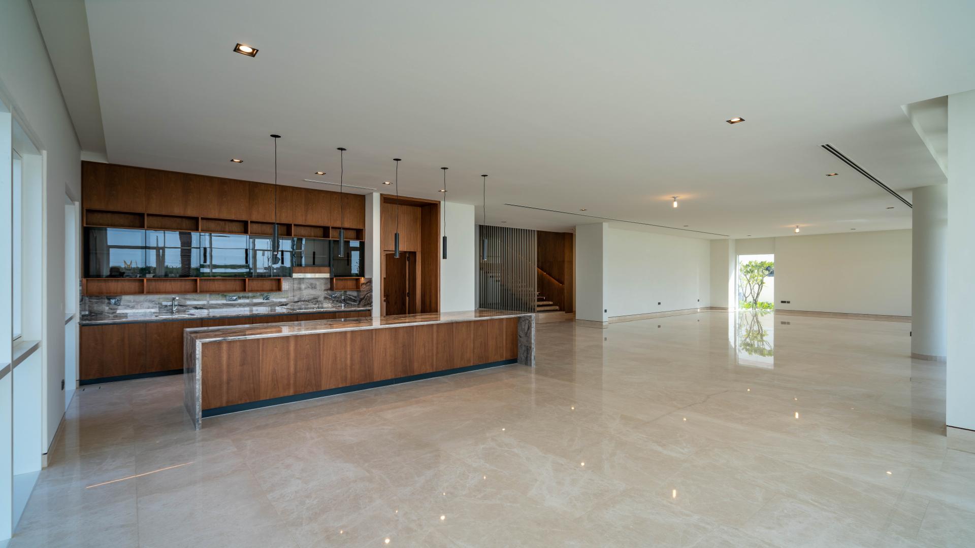 "Spacious Dubai Hills Estate villa entrance with modern design and elegant staircase in Golf Place.",Luxurious open-plan kitchen and living area in Dubai Hills Estate villa for sale