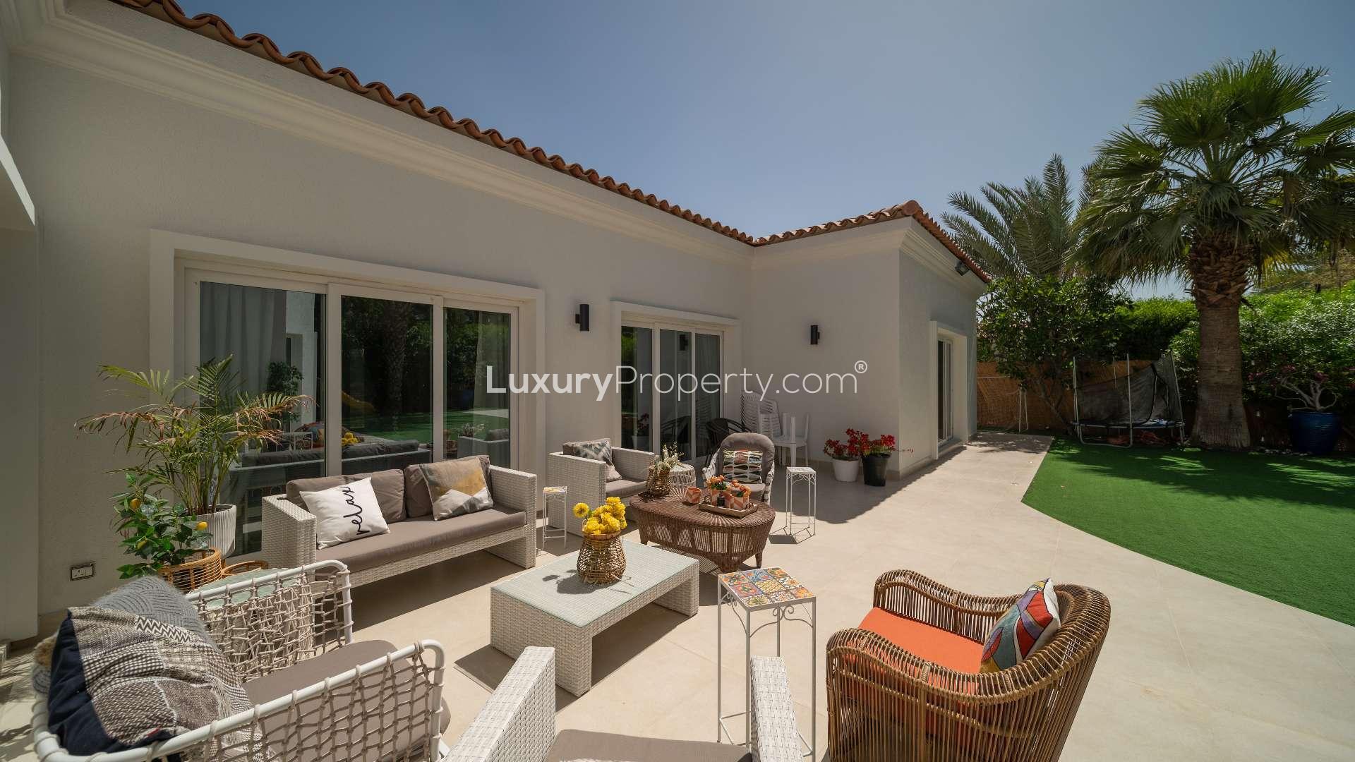 Spacious living room in 4-bedroom bungalow, Green Community West, modern decor, large windows