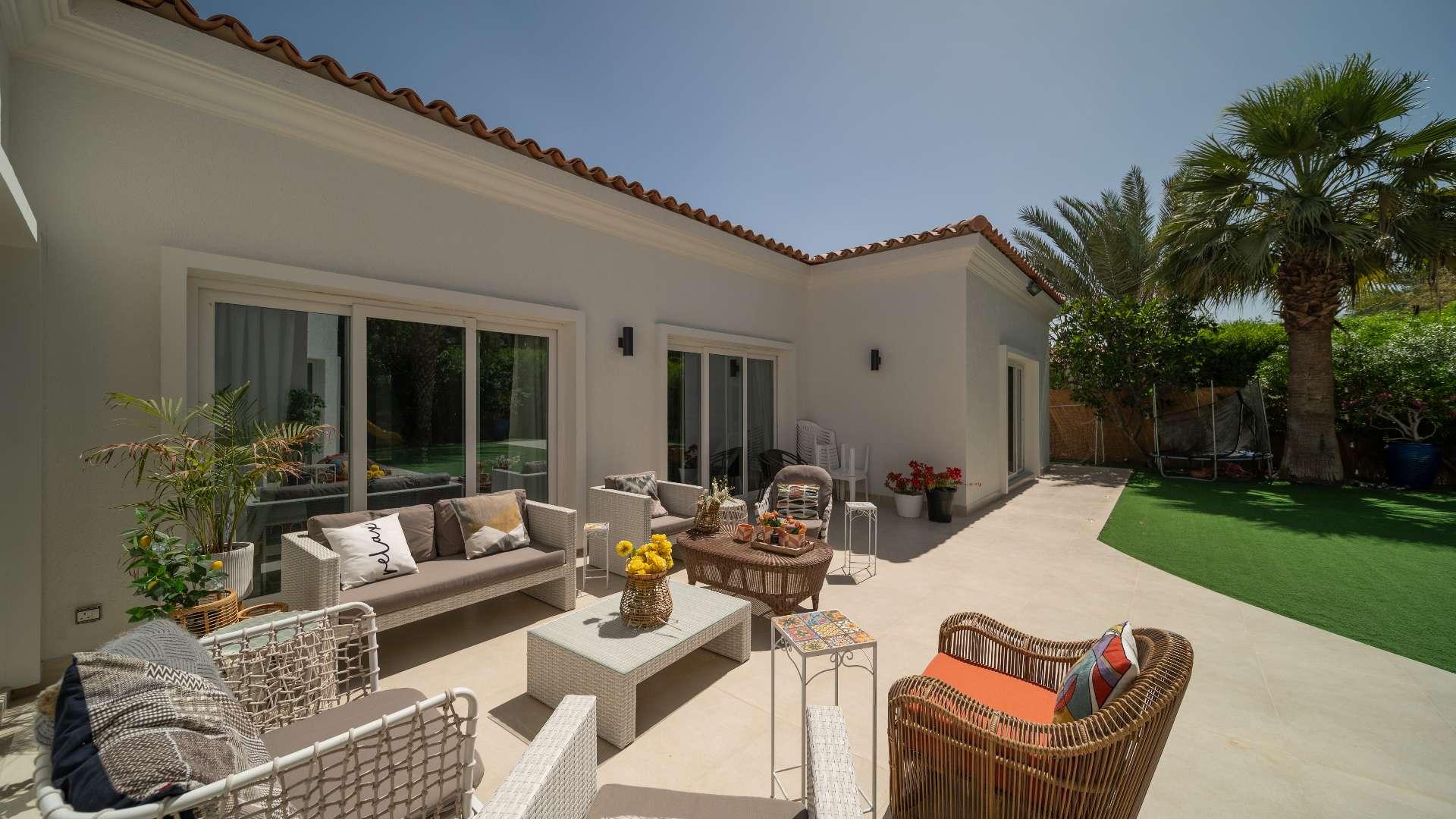 Spacious living room in 4-bedroom bungalow, Green Community West, modern decor, large windows