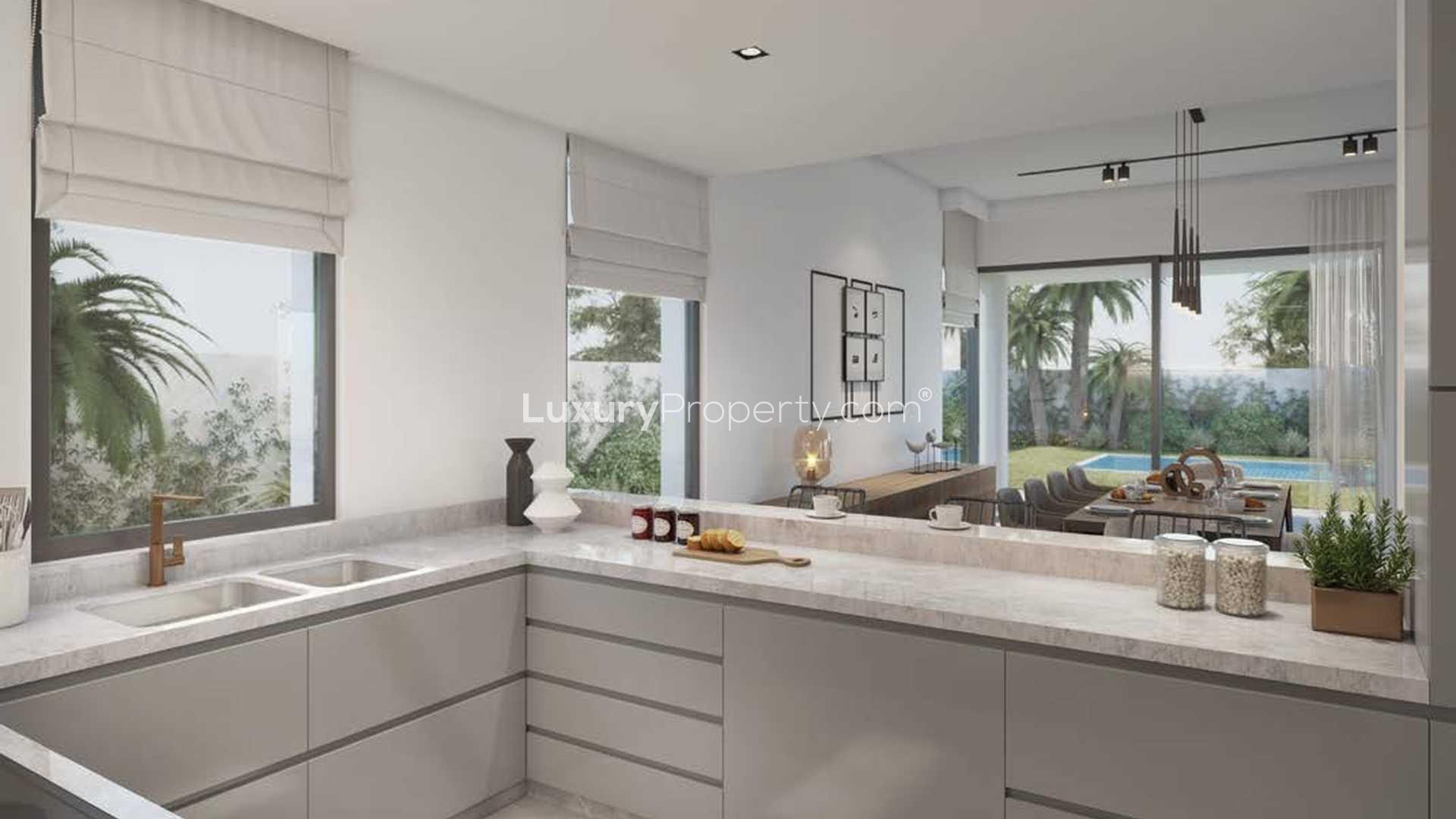 Luxurious living room in Harmony Villa, Tilal Al Ghaf with modern decor and garden views