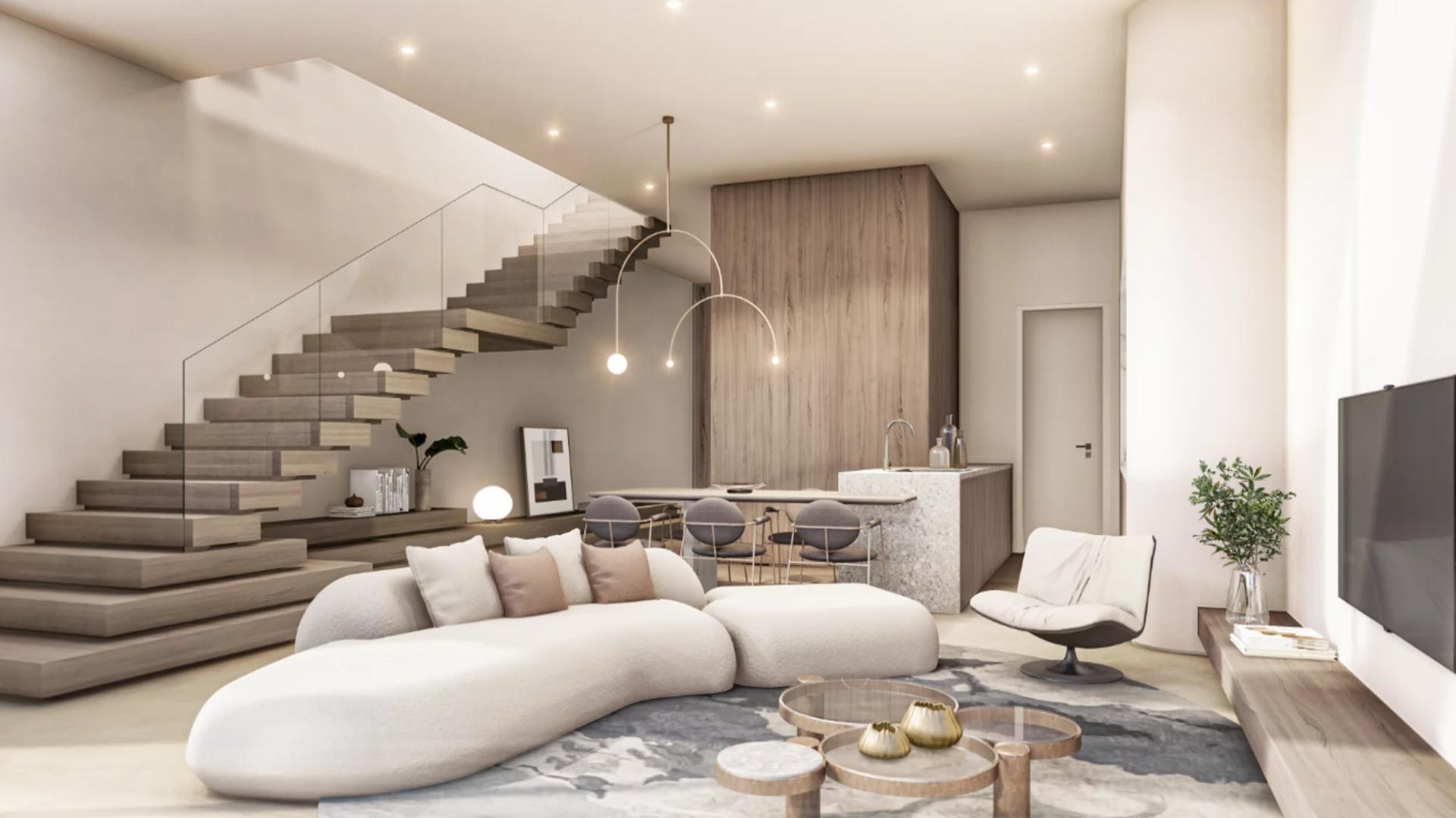 Modern living room in four-bedroom villa, Nadd Al Sheba, elegant staircase and cozy seating area