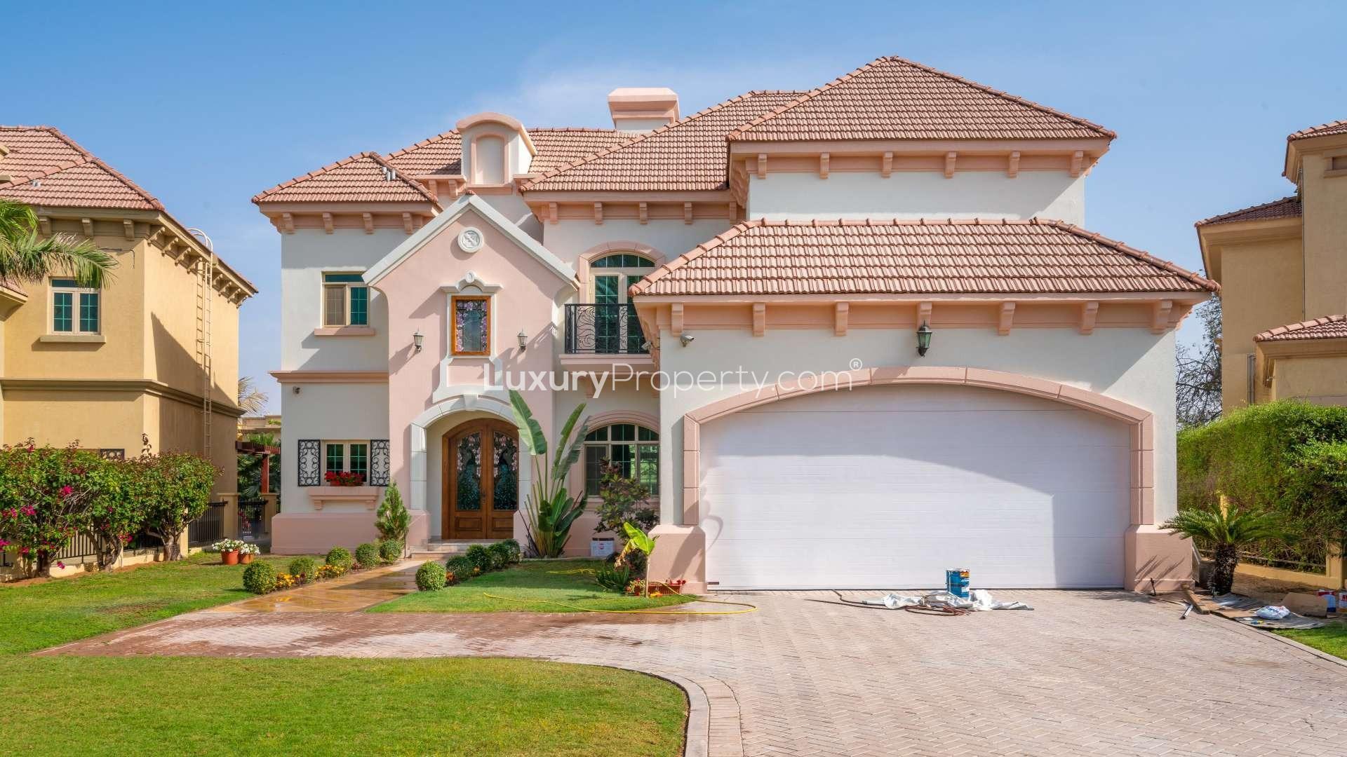 Grand staircase in luxury Jumeirah Islands villa with large windows and marble floors