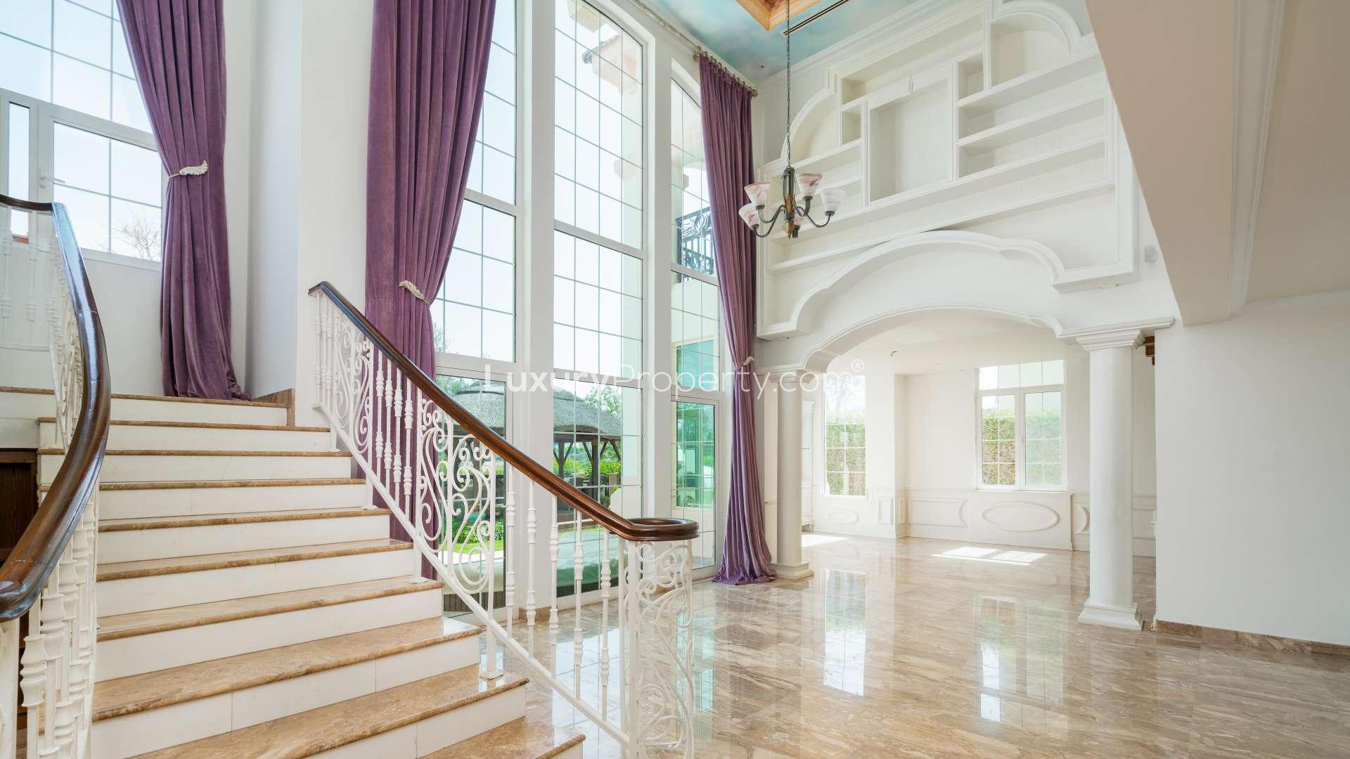 Elegant wood-paneled room in luxury Jumeirah Islands villa with large window and decorative niches