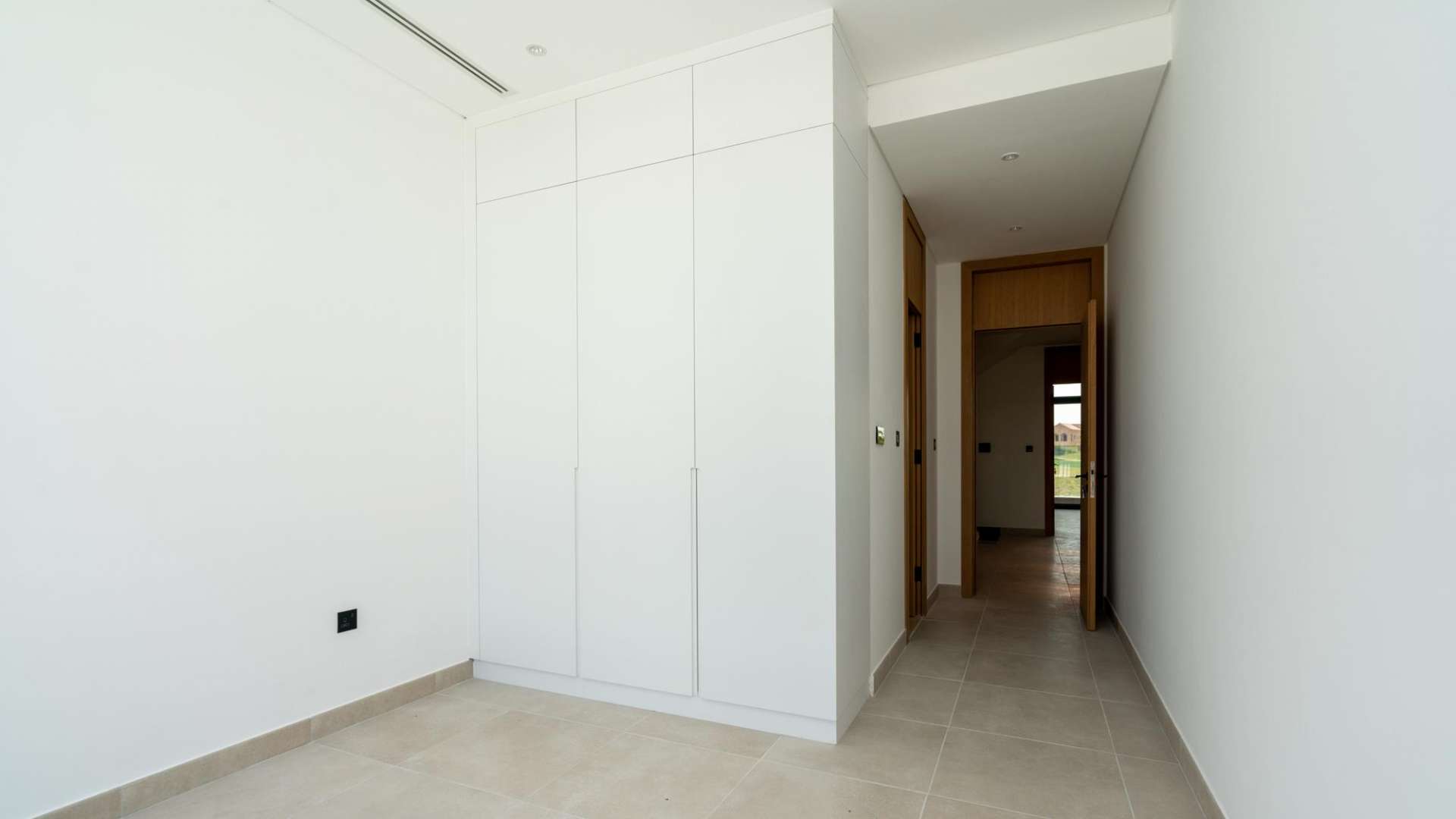 Modern walk-in closet in Jumeirah Luxury Villa, featuring open shelving and drawers