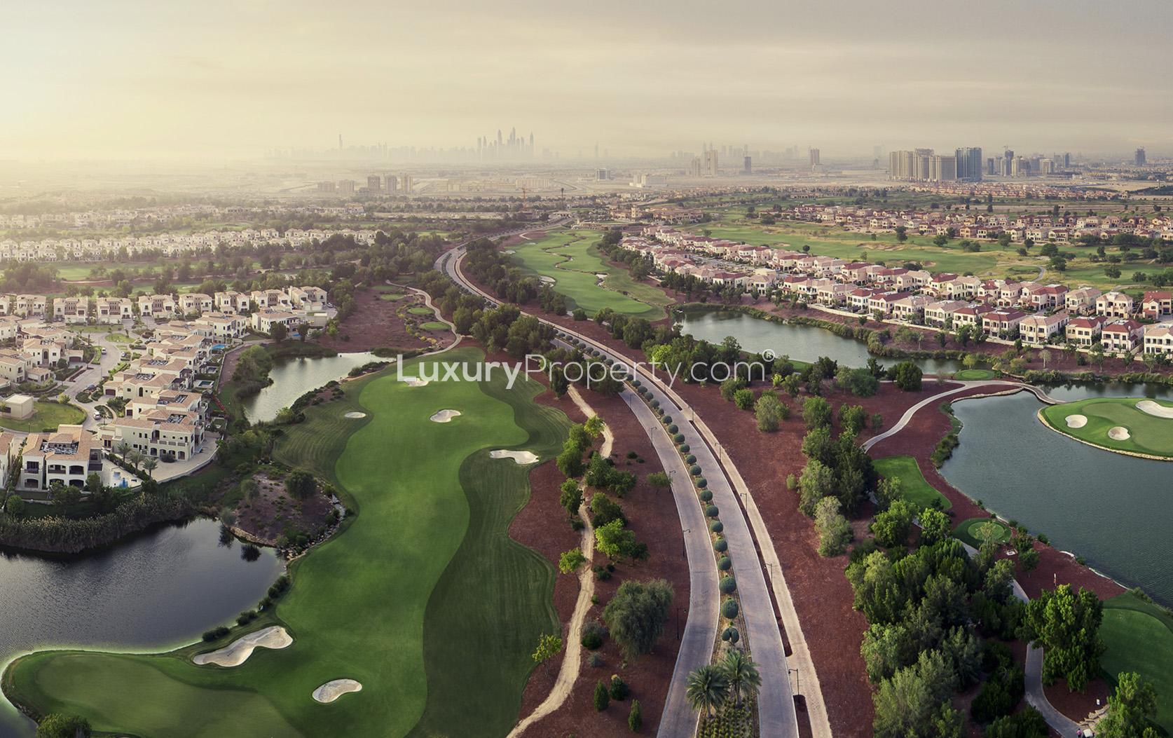 Contemporary townhouse exterior at dusk, Jumeirah Golf Estates, luxury villa for sale