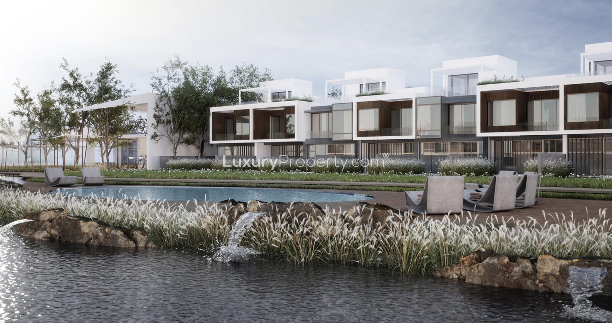 Sunset view of Jumeirah Luxury villas with lush greenery and water features