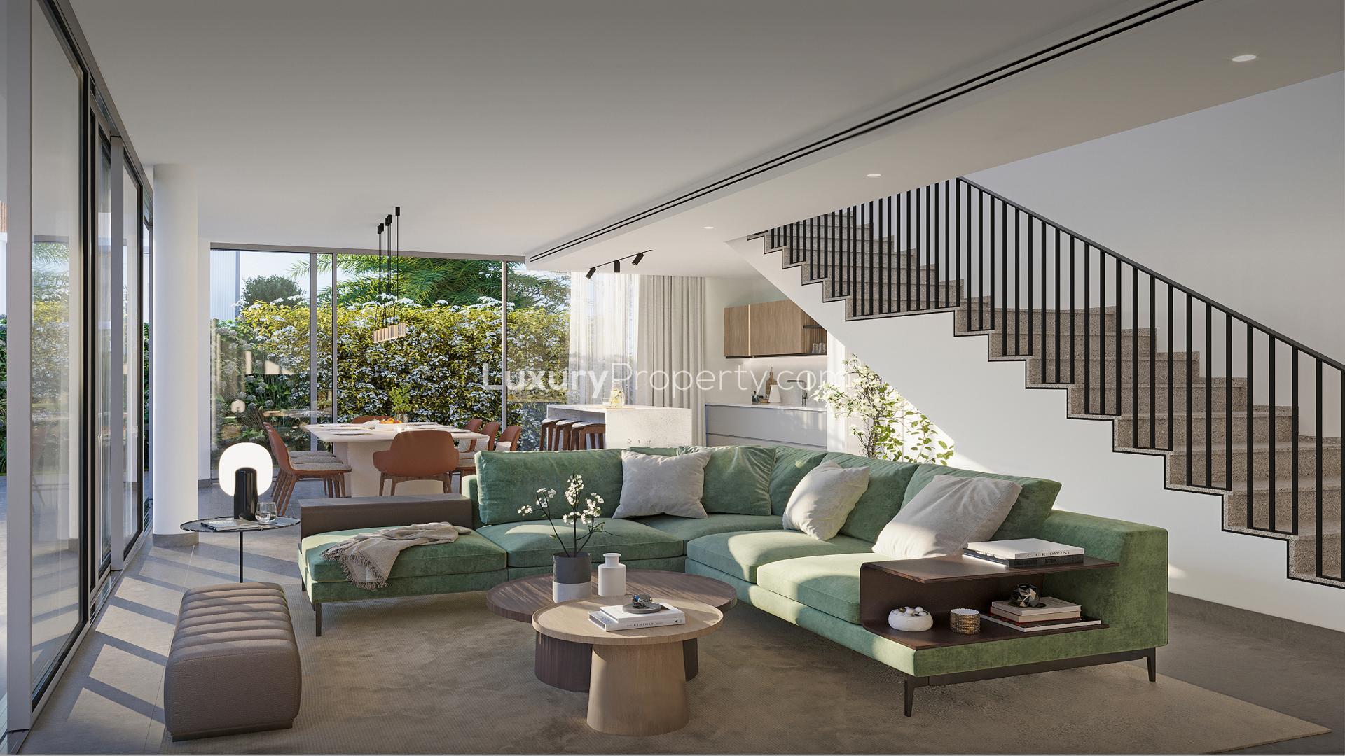 Modern living room in Arabian Ranches 3 villa with garden view through large windows