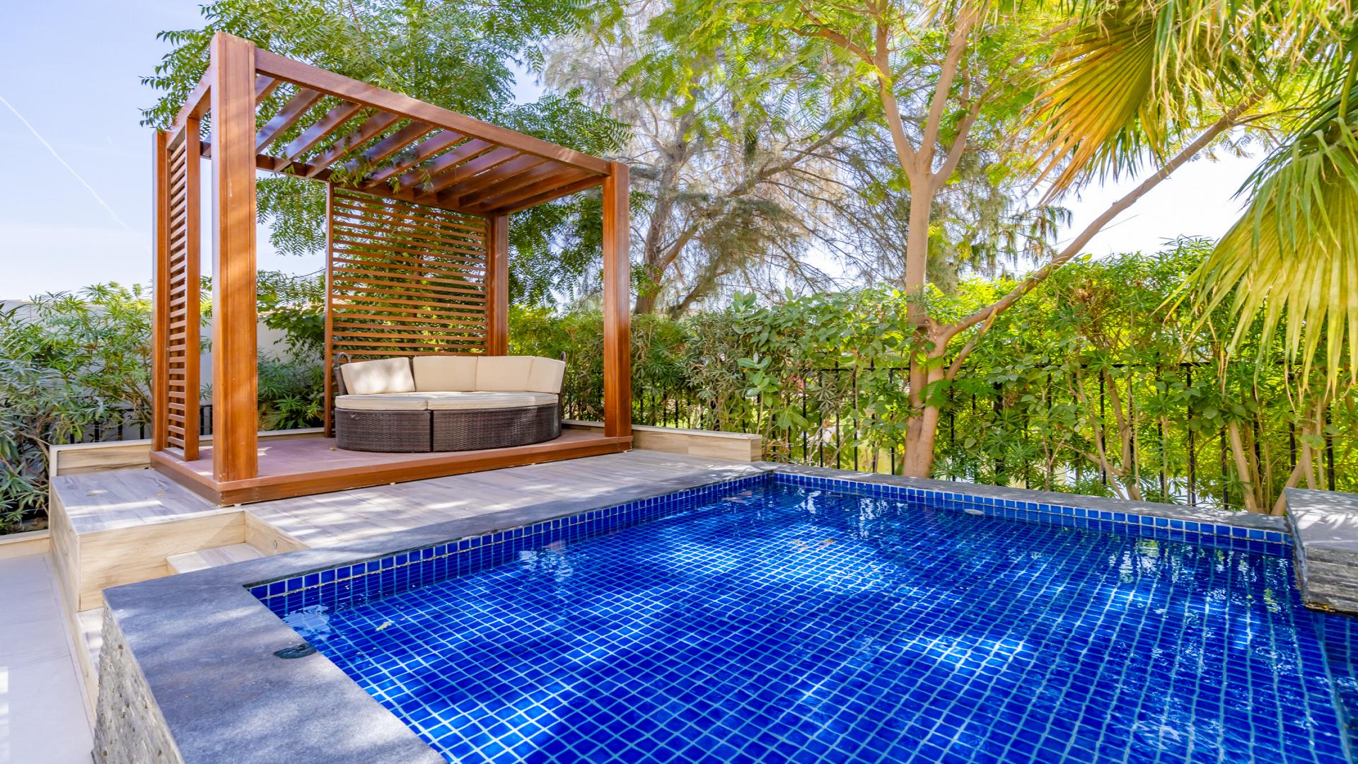Luxurious villa pool with lush greenery in Jumeirah Islands, Islamic Clusters