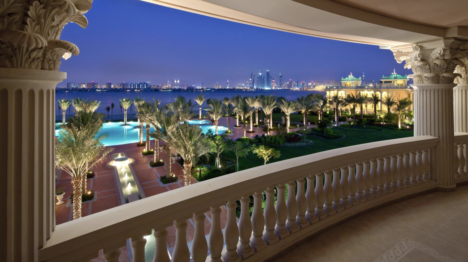 Luxurious four-bedroom villa exterior at Kempinski Palm Residence, Palm Jumeirah, surrounded by lush greenery