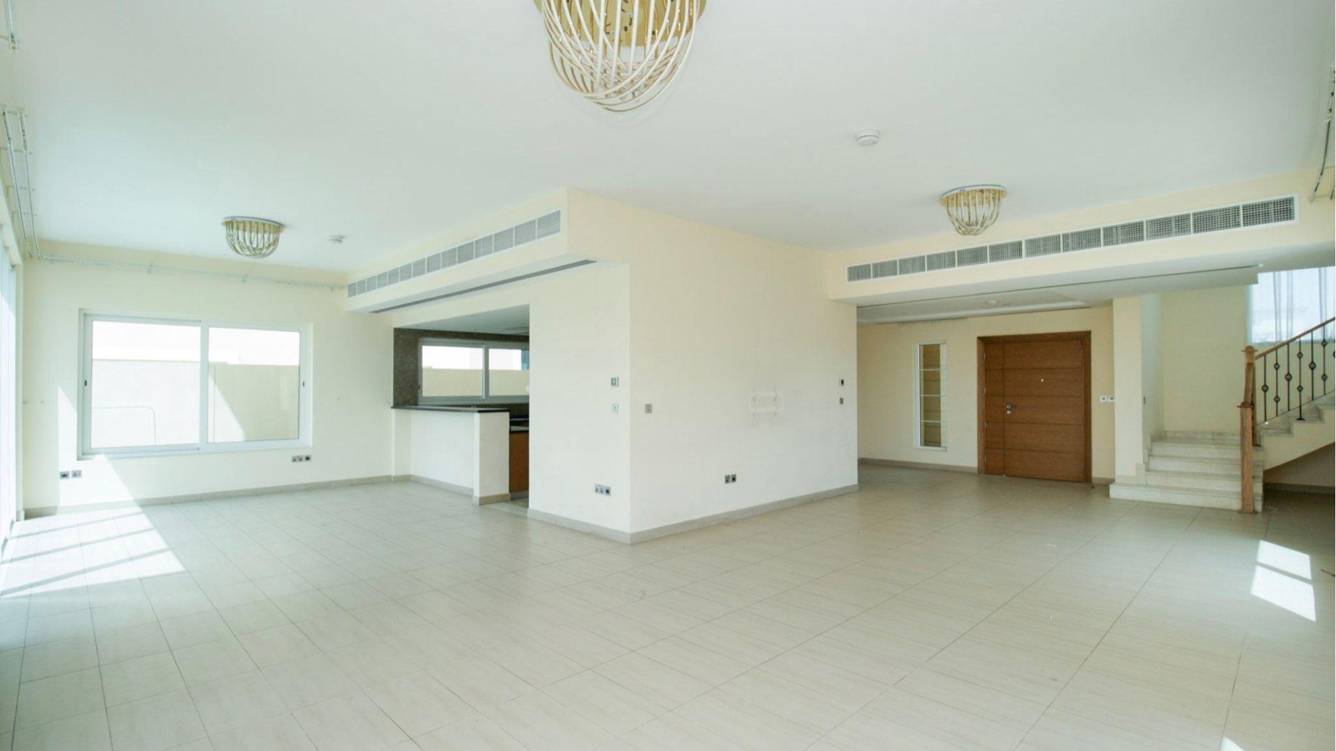 Bright, spacious living area in Jumeirah Park villa, Dubai, featuring large windows and tile flooring