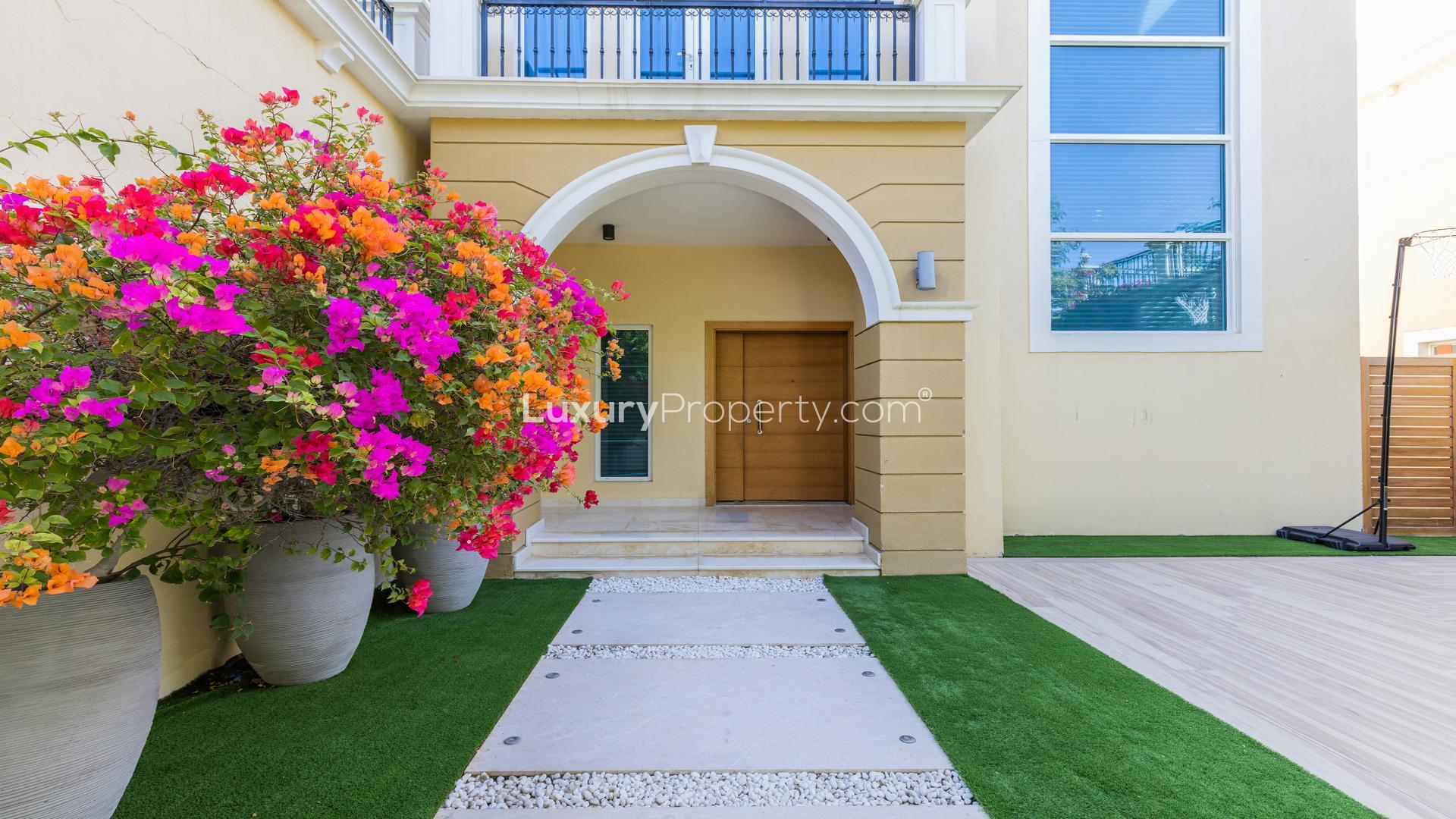 "Stunning upgraded villa with pool in Jumeirah Park, Legacy Nova Villas for sale.",Front entrance of upgraded villa with vibrant flowers, Jumeirah Park, Legacy Nova Villas