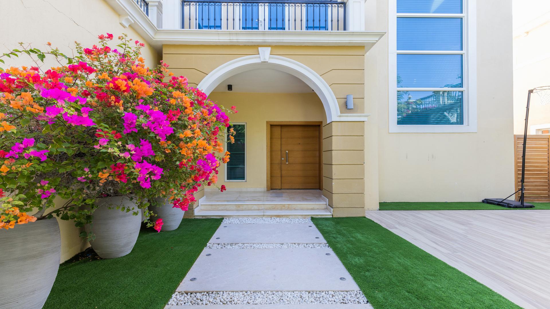 "Stunning upgraded villa with pool in Jumeirah Park, Legacy Nova Villas for sale.",Front entrance of upgraded villa with vibrant flowers, Jumeirah Park, Legacy Nova Villas