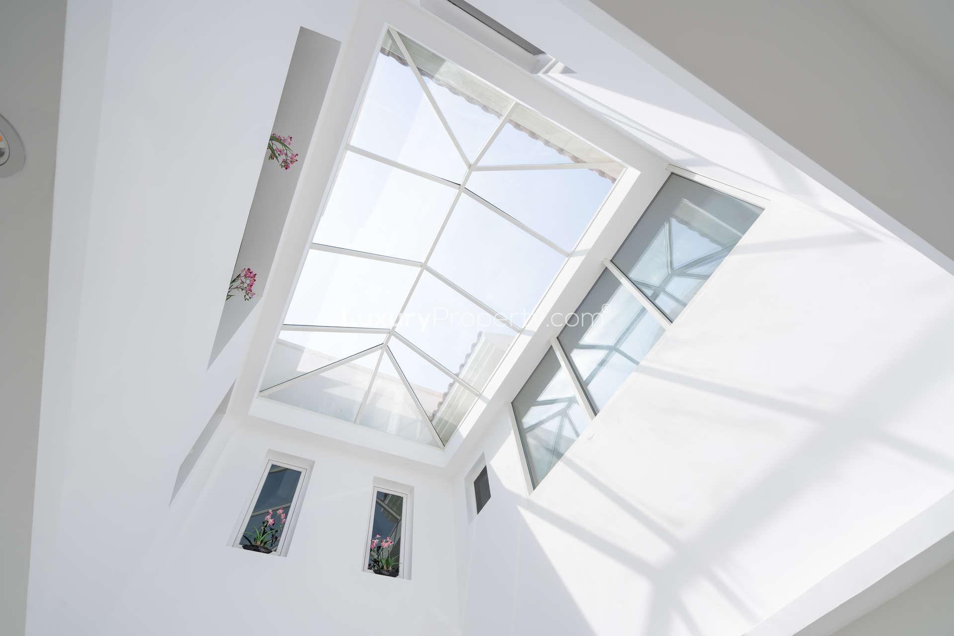 Bright, spacious villa interior with modern staircase in Jumeirah Golf Estates, Earth community