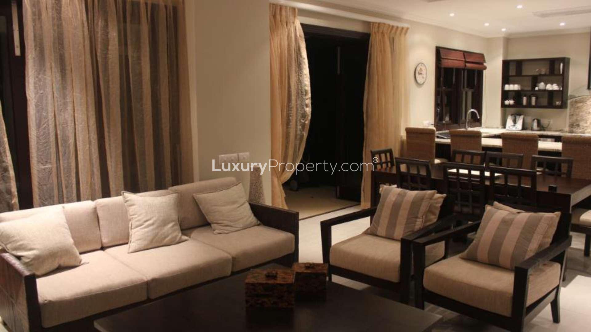 Luxurious living room in Eden Island villa with modern decor and open kitchen