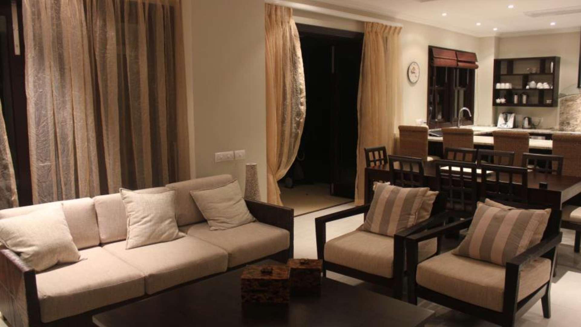 Luxurious living room in Eden Island villa with modern decor and open kitchen