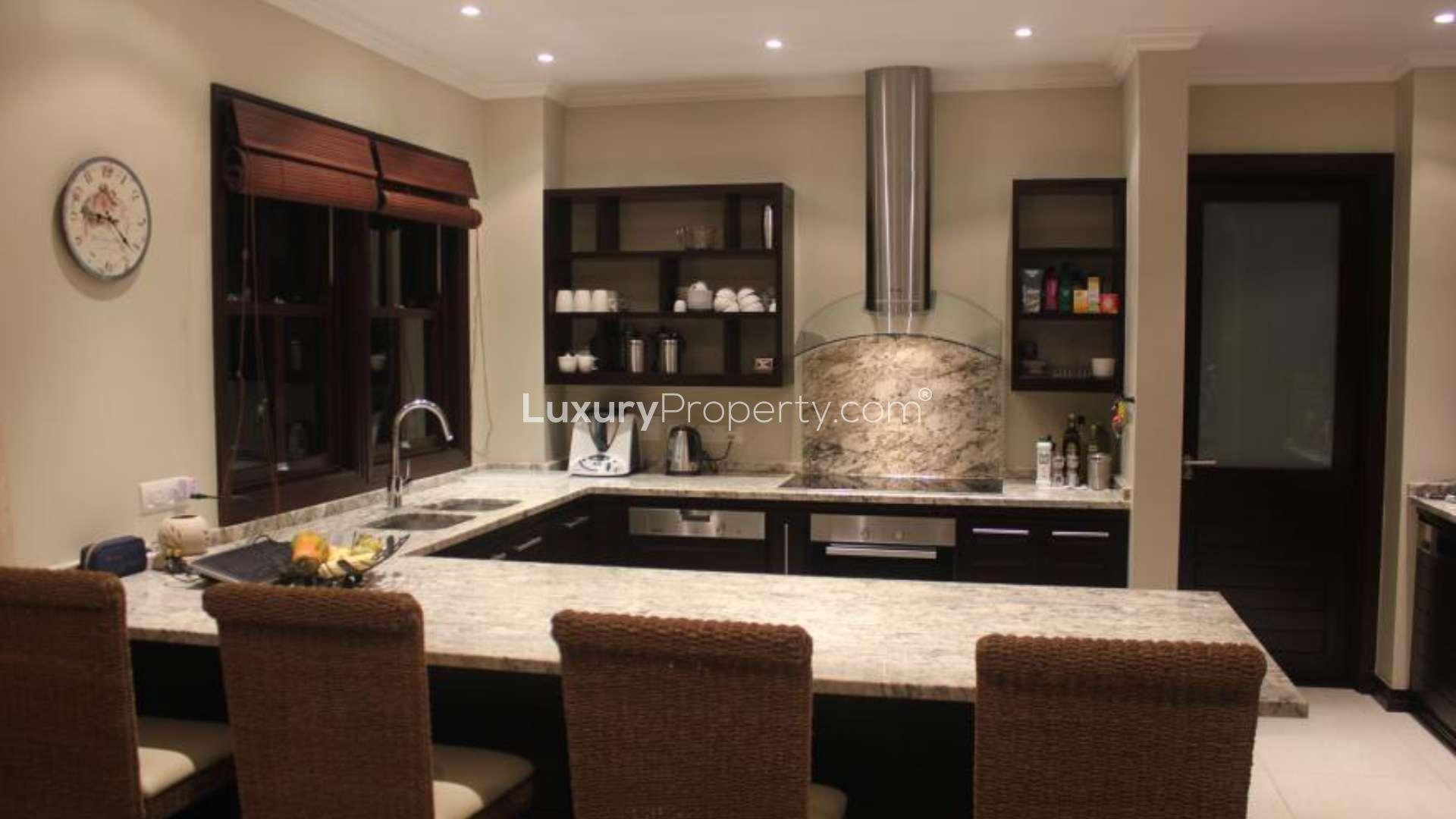 Modern kitchen in Eden Island villa with marble countertops and sleek appliances