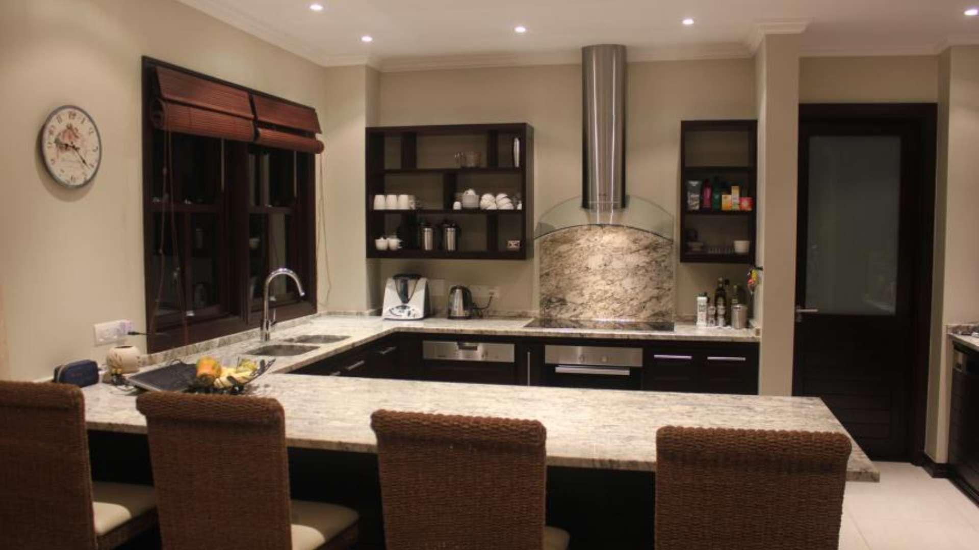 Modern kitchen in Eden Island villa with marble countertops and sleek appliances