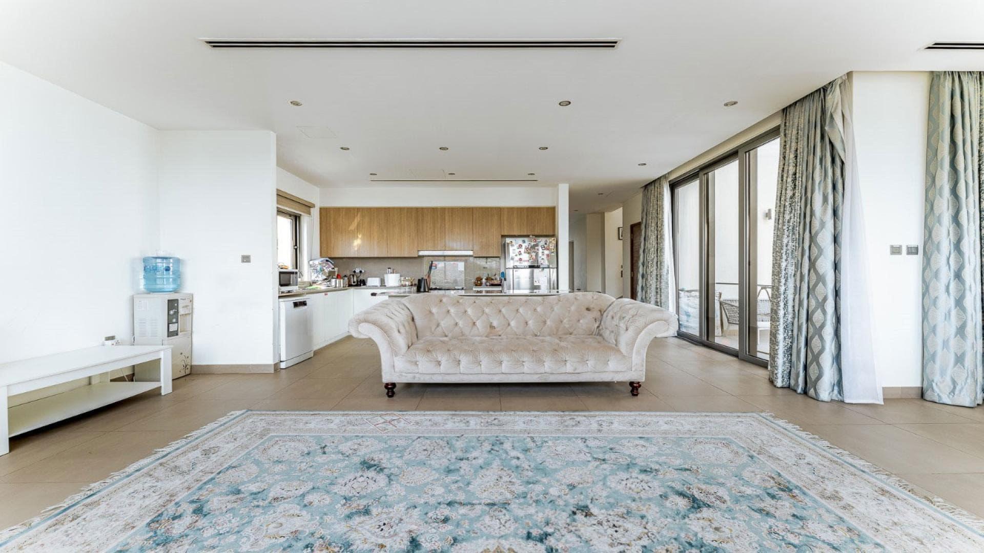 "Elevated villa view of lush park and modern architecture in Sidra Villas, Dubai Hills Estate.",Spacious living room with elegant sofa and modern kitchen in Sidra 3 villa, Dubai Hills Estate