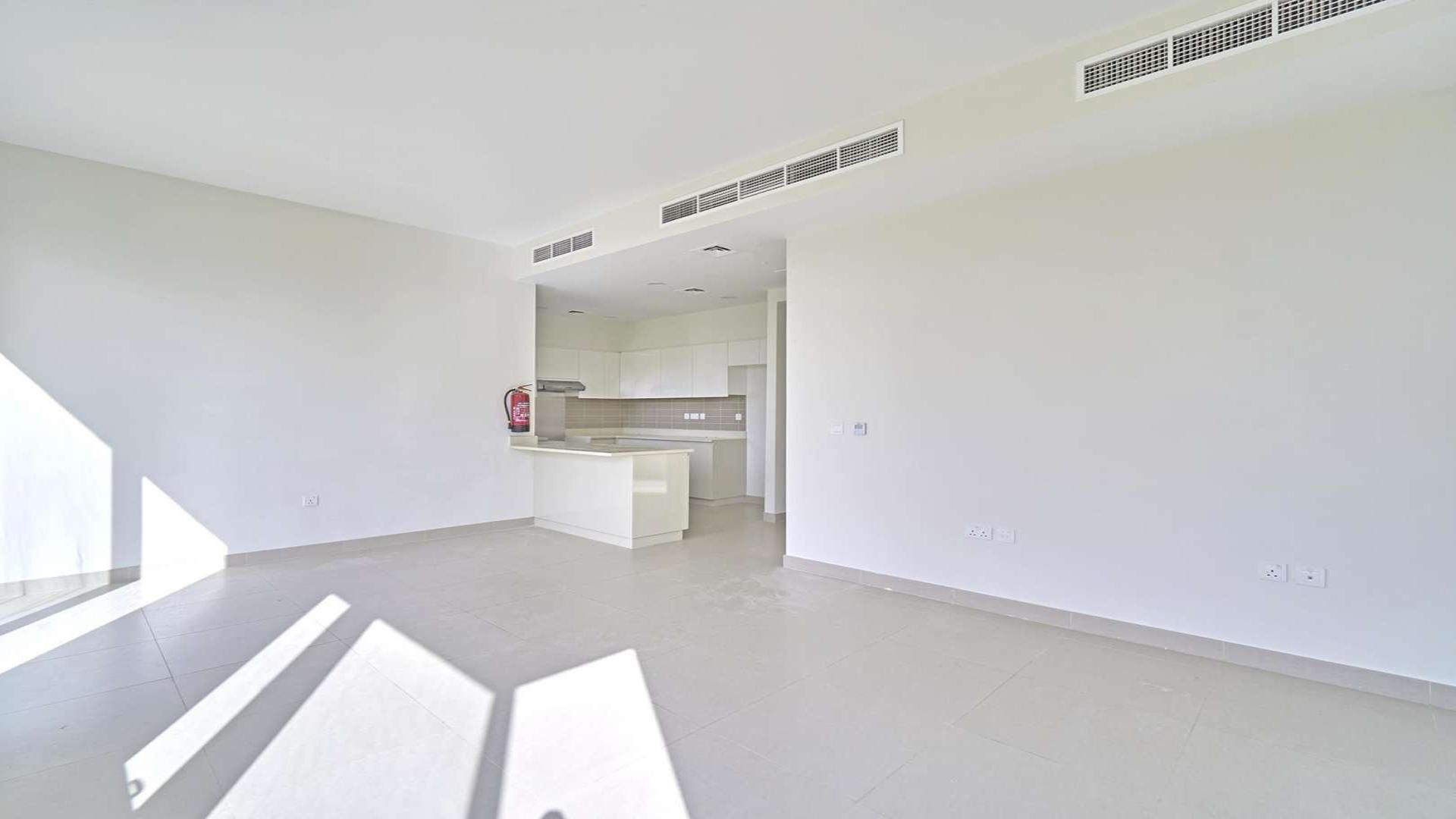 Modern single-row villa exterior in Maple 1, Dubai Hills Estate, lush green yard