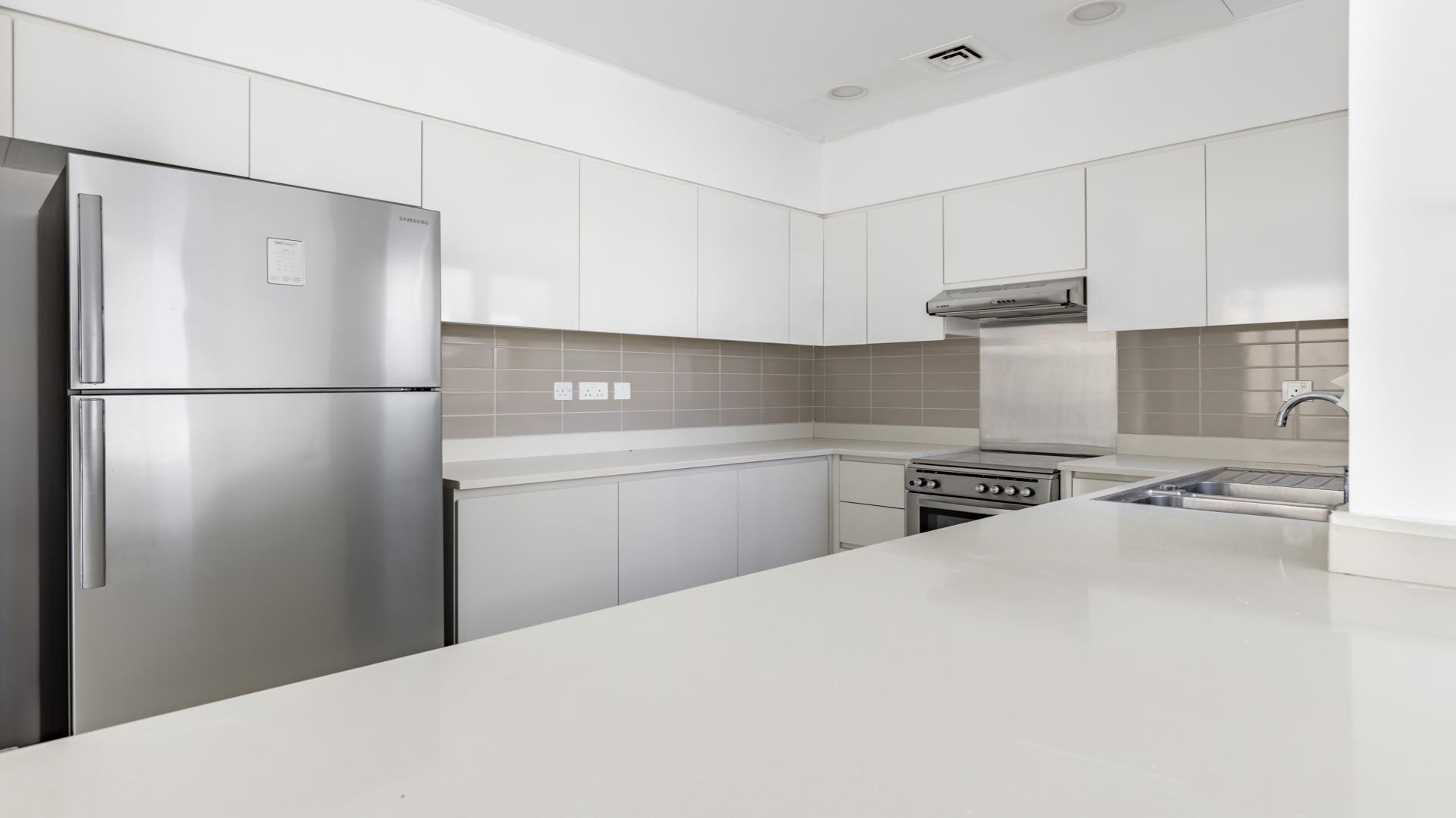 "Spacious living area in 4-bedroom villa, Maple 1, Dubai Hills Estate, for sale.",Modern kitchen in Type 2E villa, Maple 1, Dubai Hills Estate, with sleek white cabinets