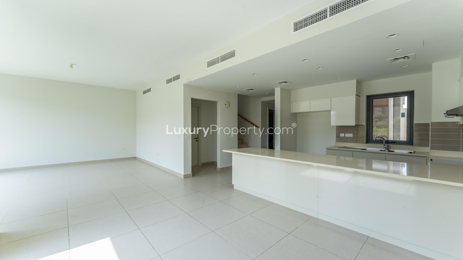 Bright living area in Maple Villa, Dubai Hills Estate, featuring large windows and modern kitchen
