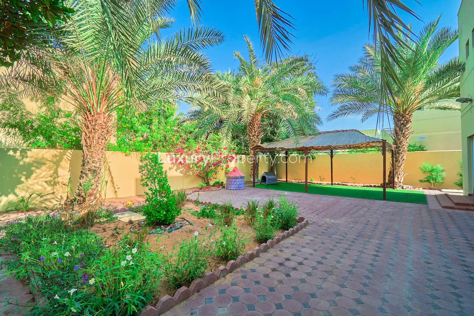 Villa for sale in Meadows 2 community, featuring modern design and spacious driveway