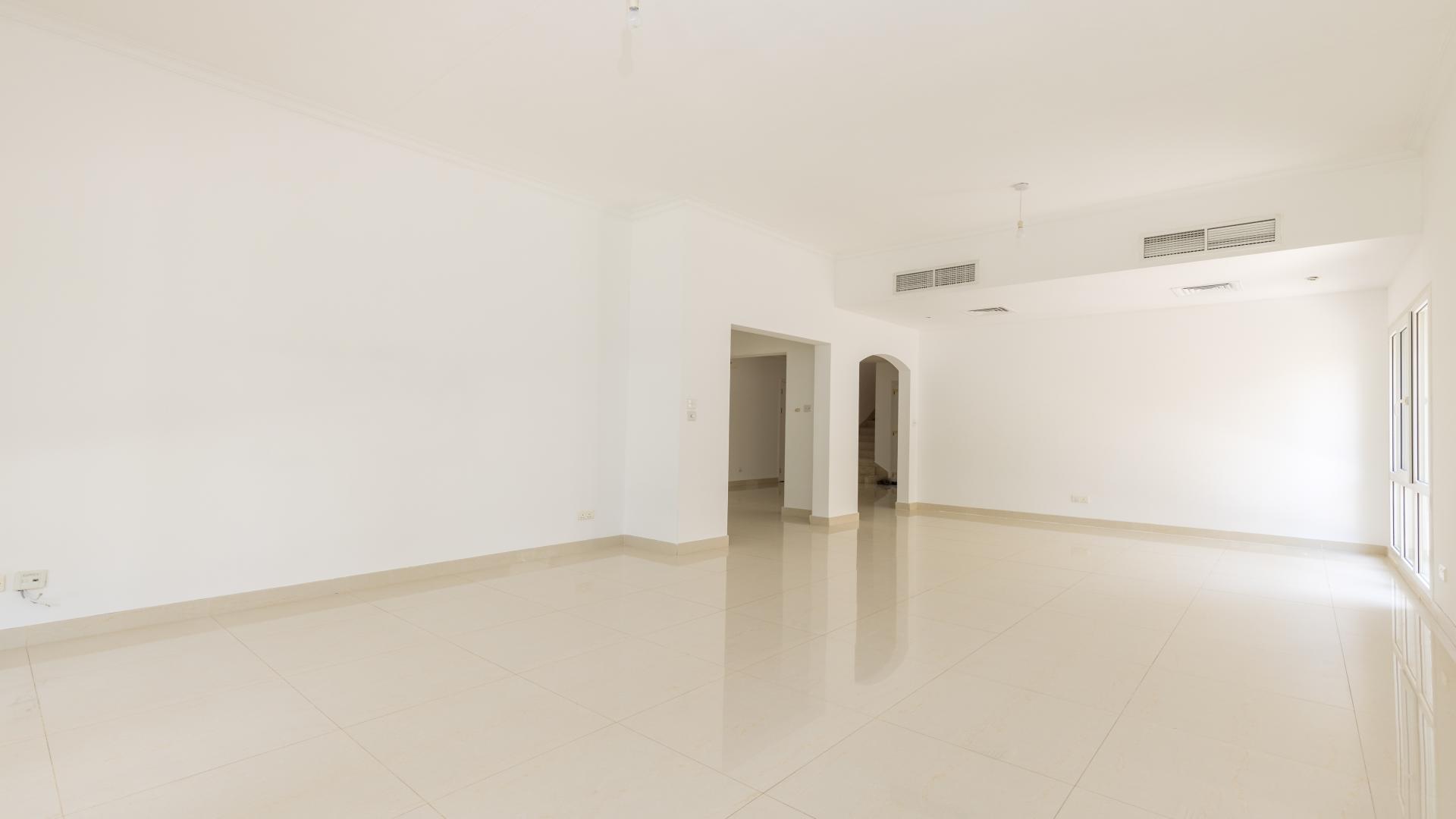 Spacious living room with large windows in Meadows 9 upgraded 4-bedroom villa for sale